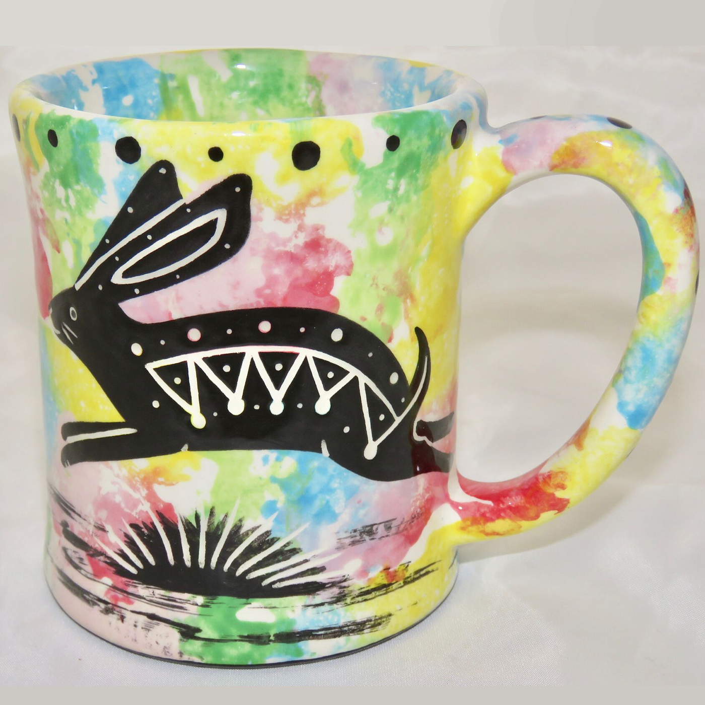 Ear handle mug, running rabbit, confetti background.
