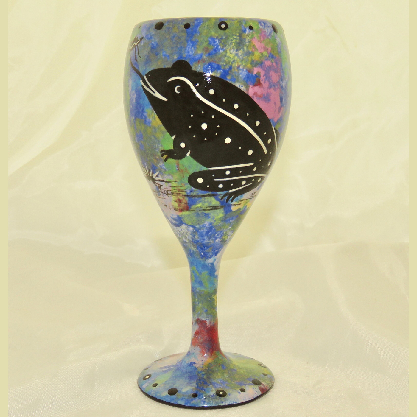 Wine glass with toad on blue