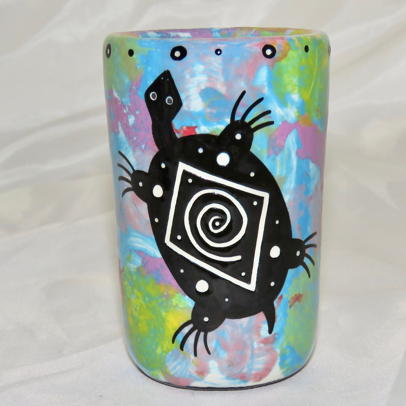 Mana Pottery clay shot glass featuring turtle on one side and native Aravaipa vegetation on reverse, on a turquoise blue backround.