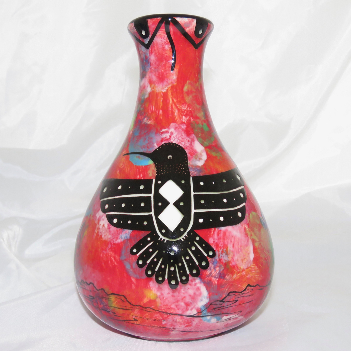 Mana Pottery Teardrop Vase with hummingbird on one side and native Aravaipa vegetation on reverse, on a background of crimson.