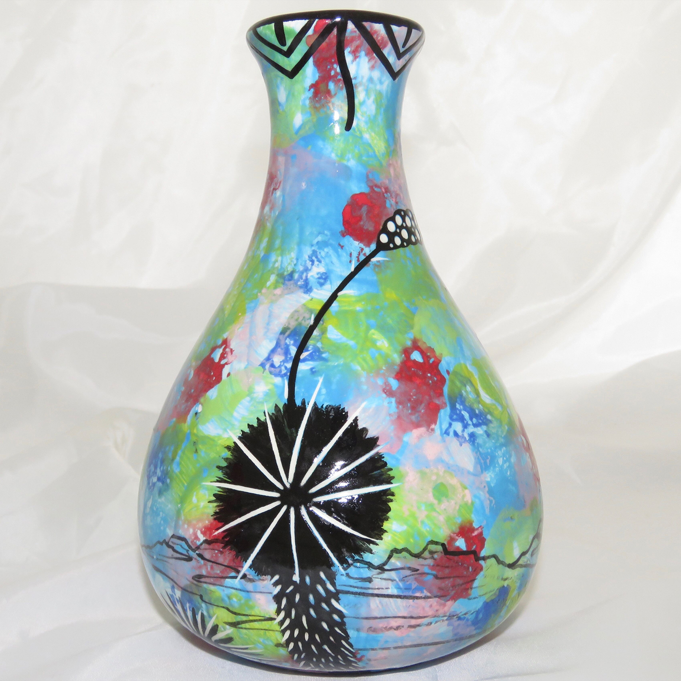 Mana Pottery Teardrop Vase with hummingbird on one side and native Aravaipa vegetation on reverse, on a background of turquoise blue. Photo shows reverse side.