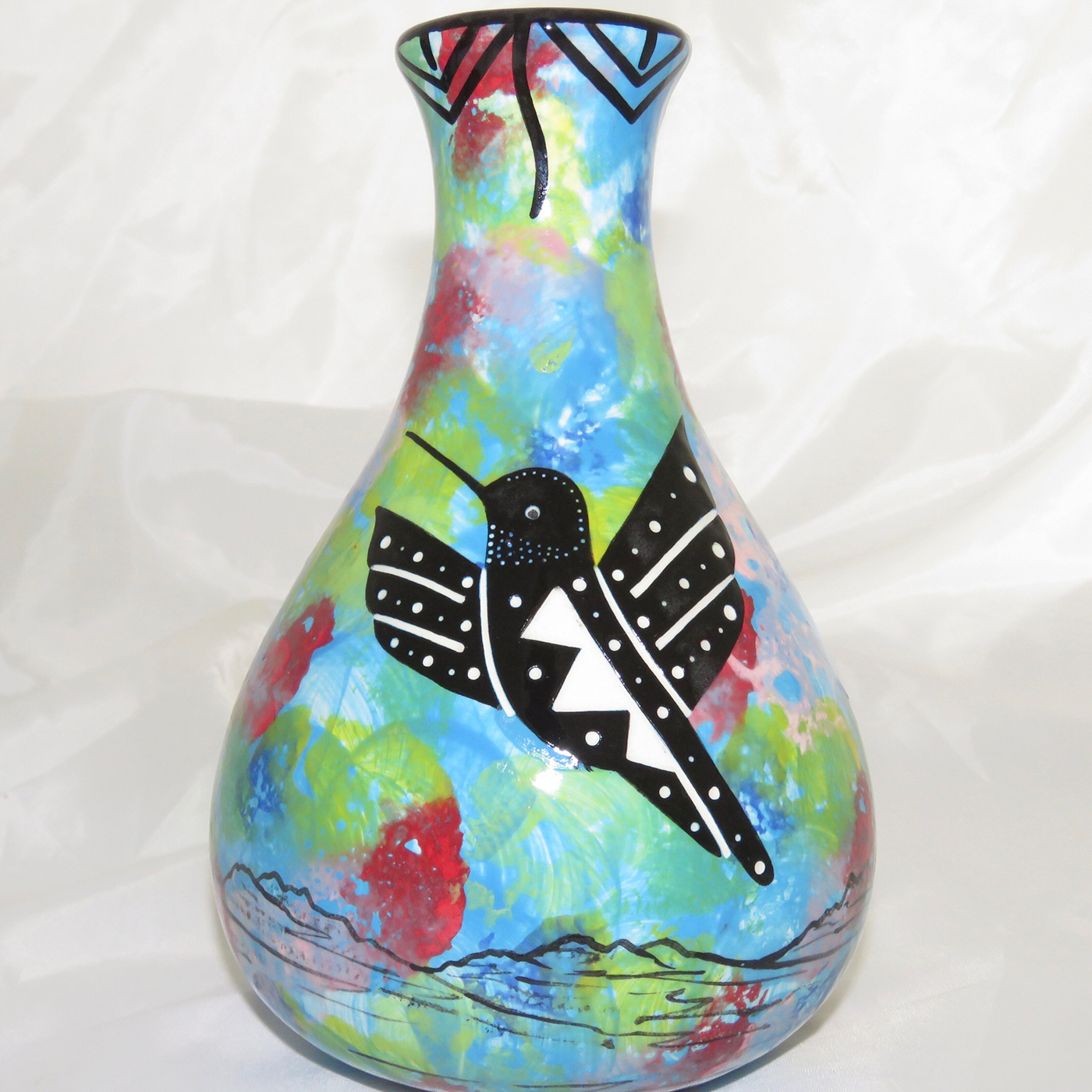 Mana Pottery Teardrop Vase with hummingbird on one side and native Aravaipa vegetation on reverse, on a background of turquoise blue.