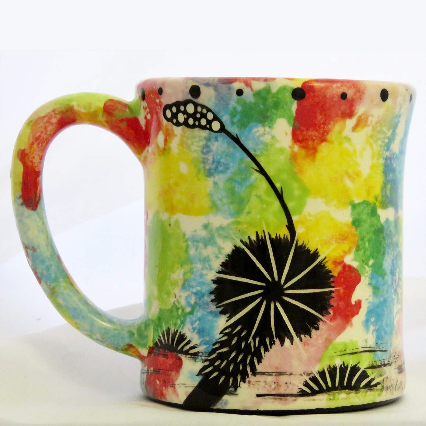 Mana Pottery e-mug with bear on confetti background. Reverse side shows Aravaipa vegetation.