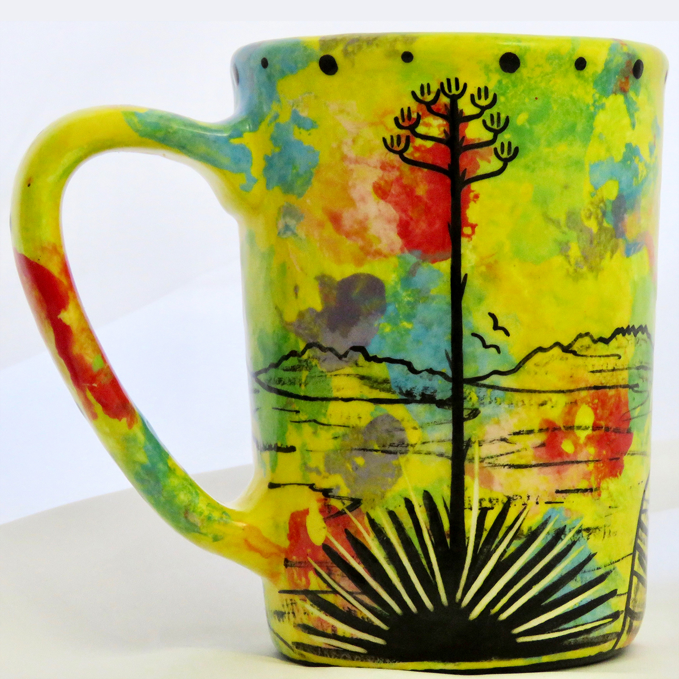 Mana Pottery large mug with puma lion on bright yellow. Reverse shows Aravaipa desert vegetation.
