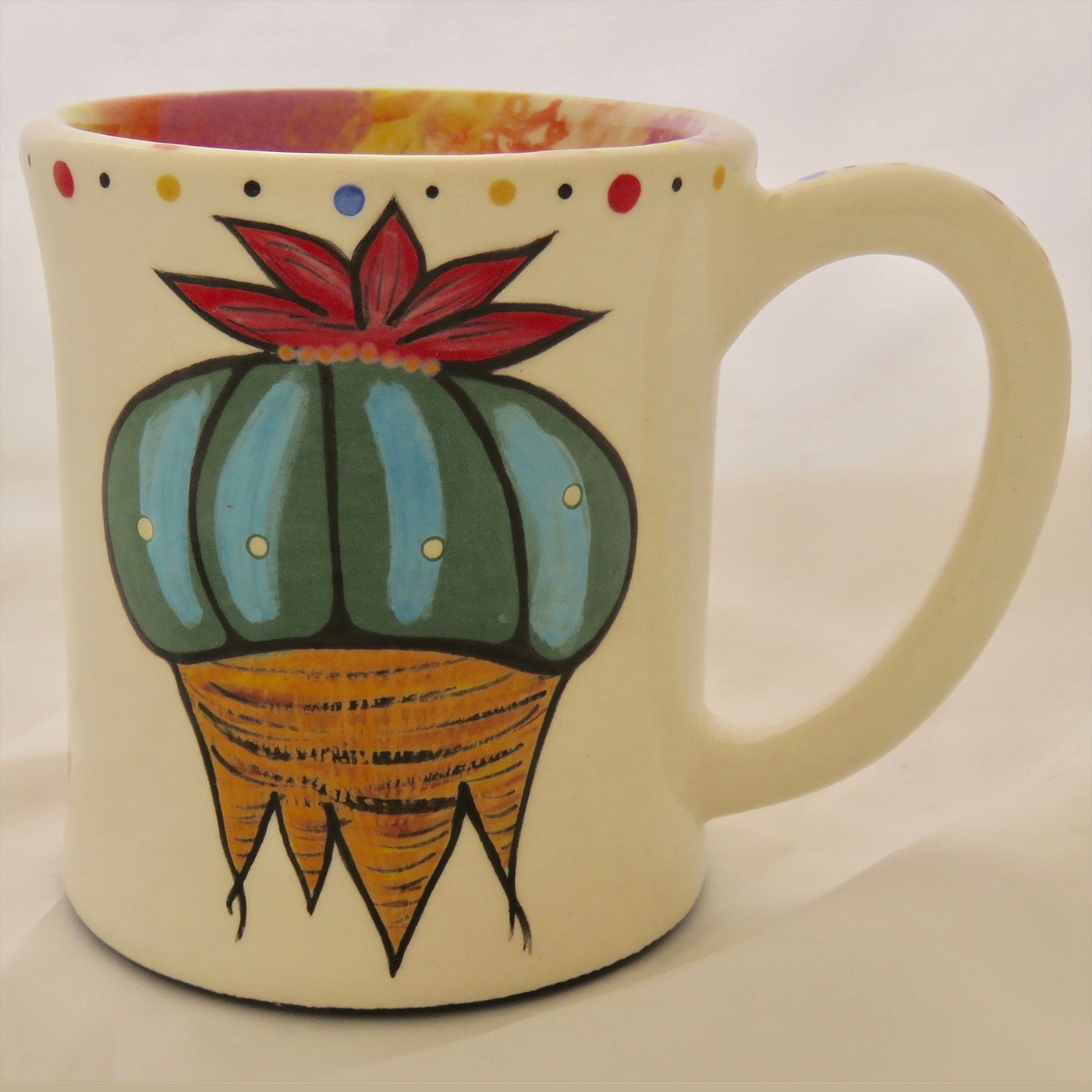 Mana Pottery emug featuring Peyote root on one side and desert vegetation on reverse, on white