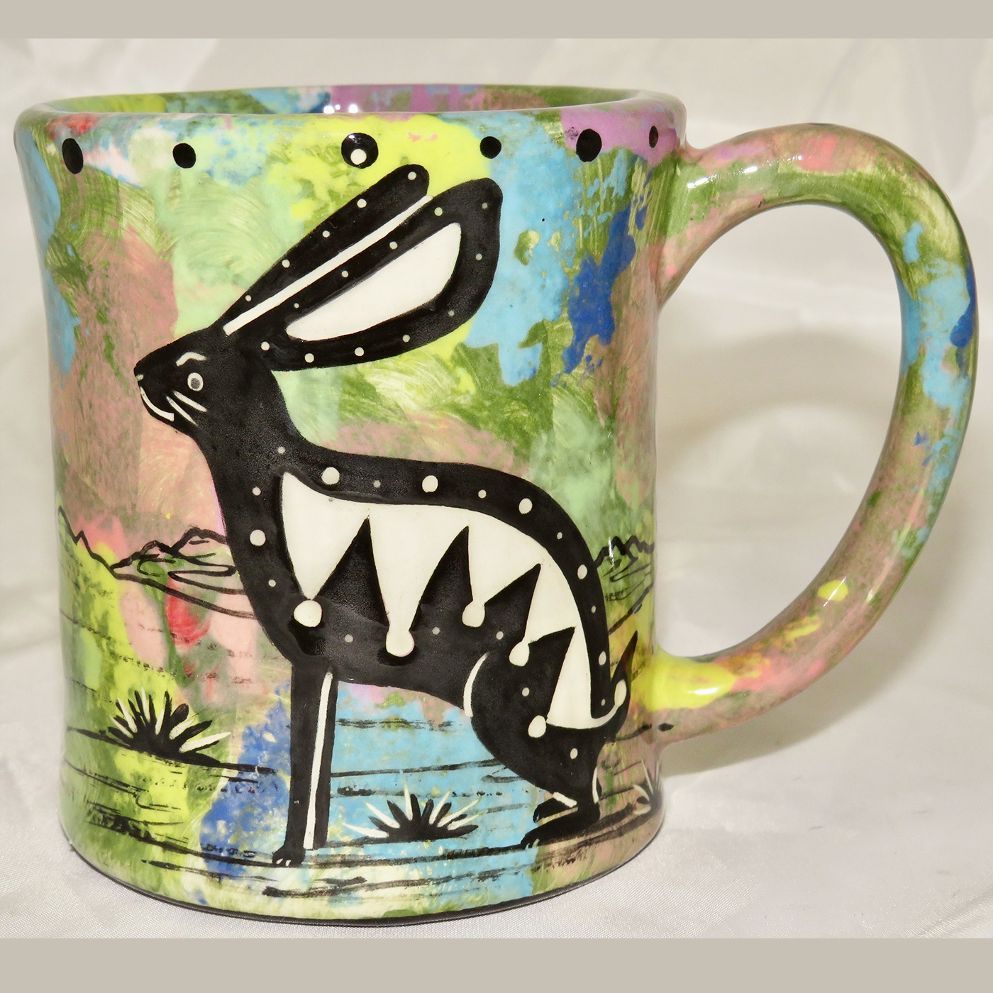 Mana Pottery e-mug featuring Arizona jackrabbit and desert landscape on reverse sides, on green background.