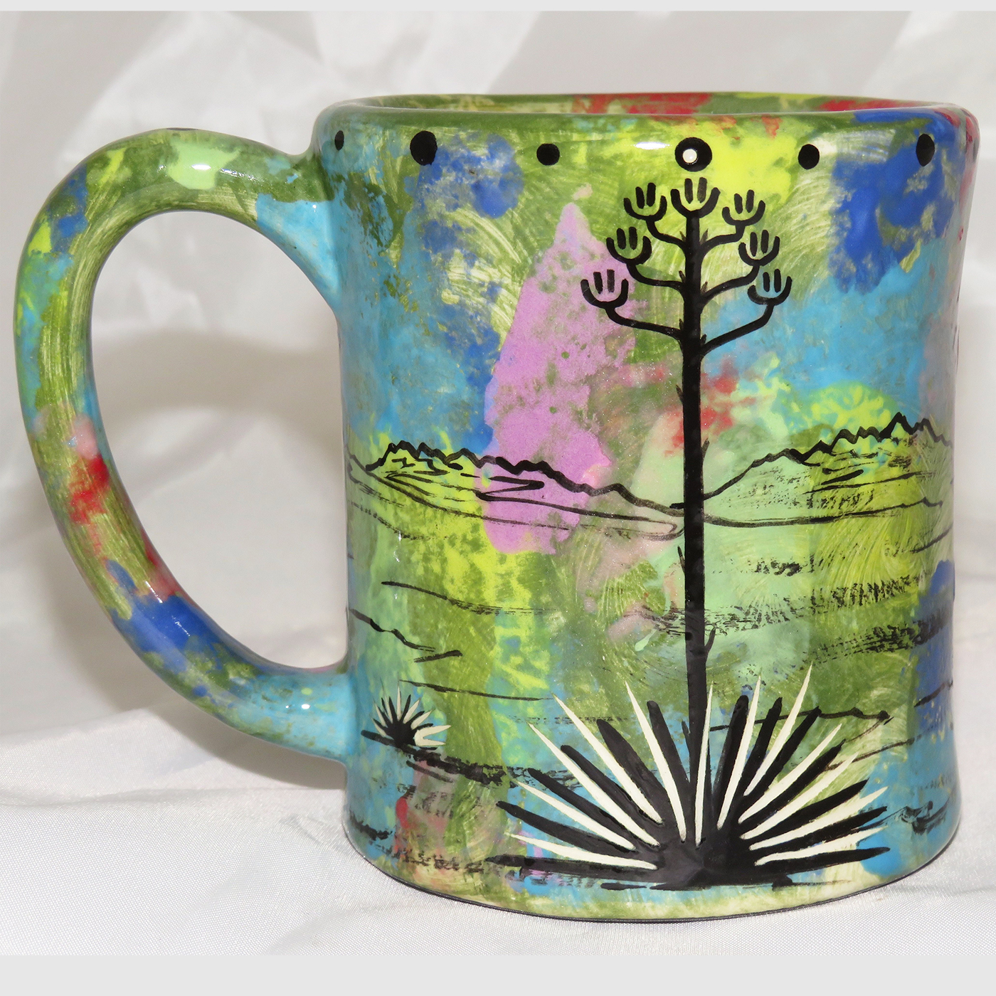 Mana Pottery e-mug featuring coyote and desert landscape on reverse sides, on green background.