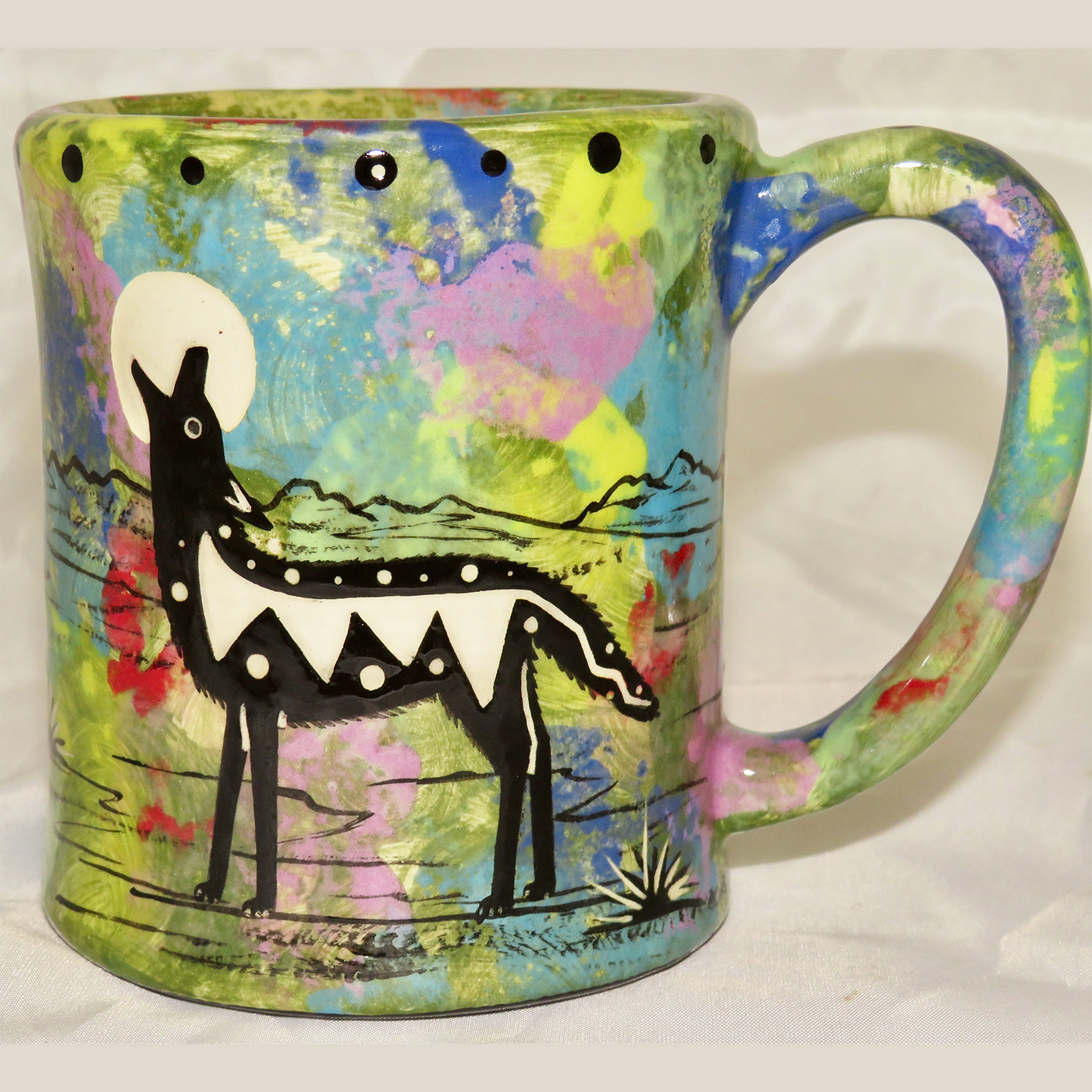 Mana Pottery e-mug featuring coyote and desert landscape on reverse sides, on green background.