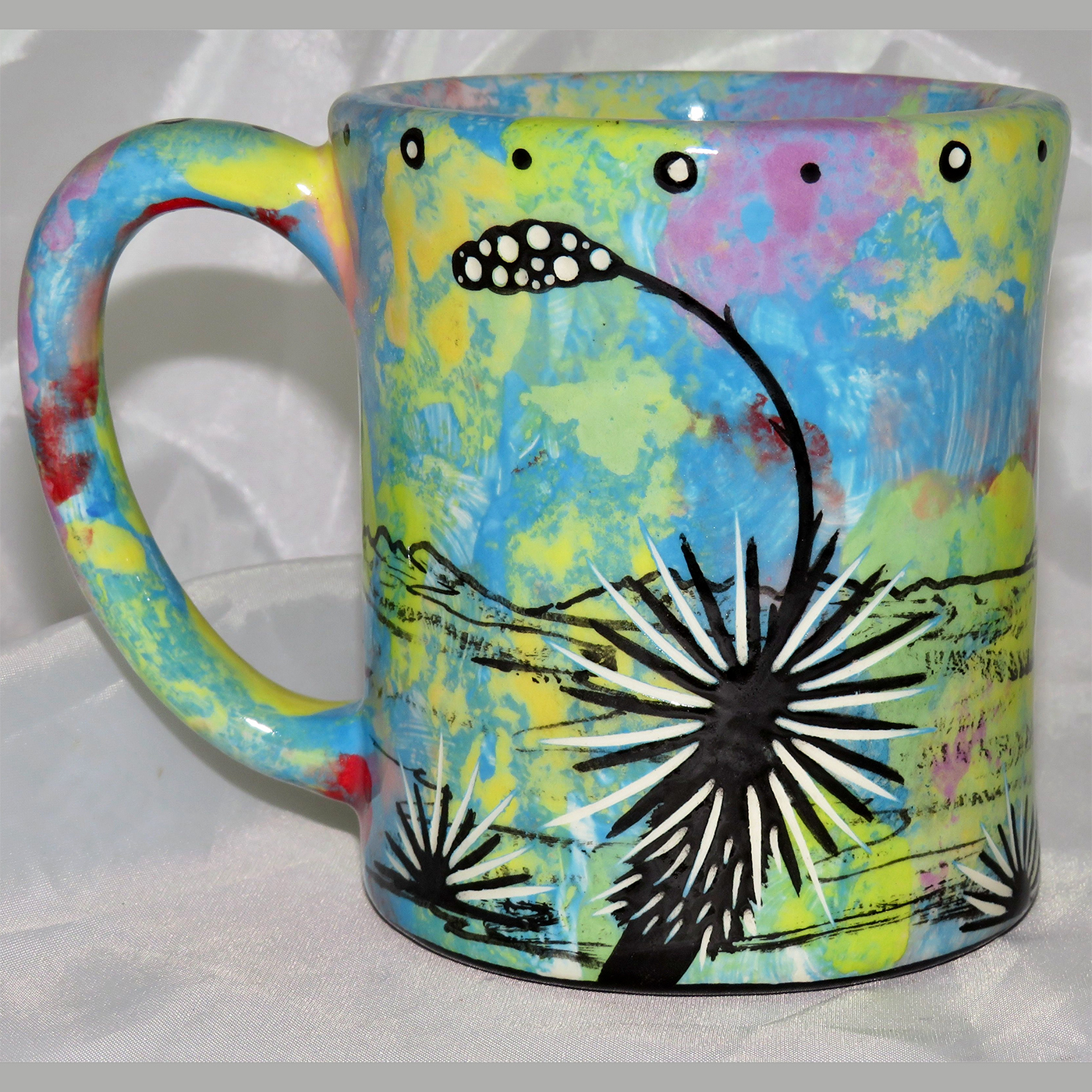 Mana Pottery e-mug featuring roadrunner and desert landscape on reverse sides, on turquoise blue background.