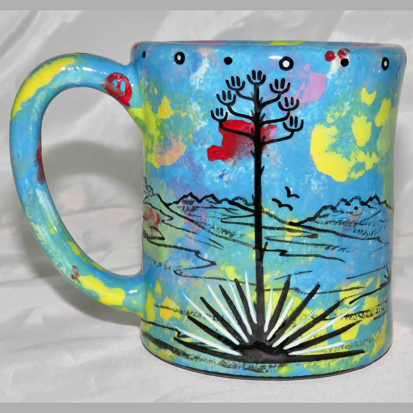 Mana Pottery e-mug featuring roadrunner and desert landscape on reverse sides, on turquoise blue background.
