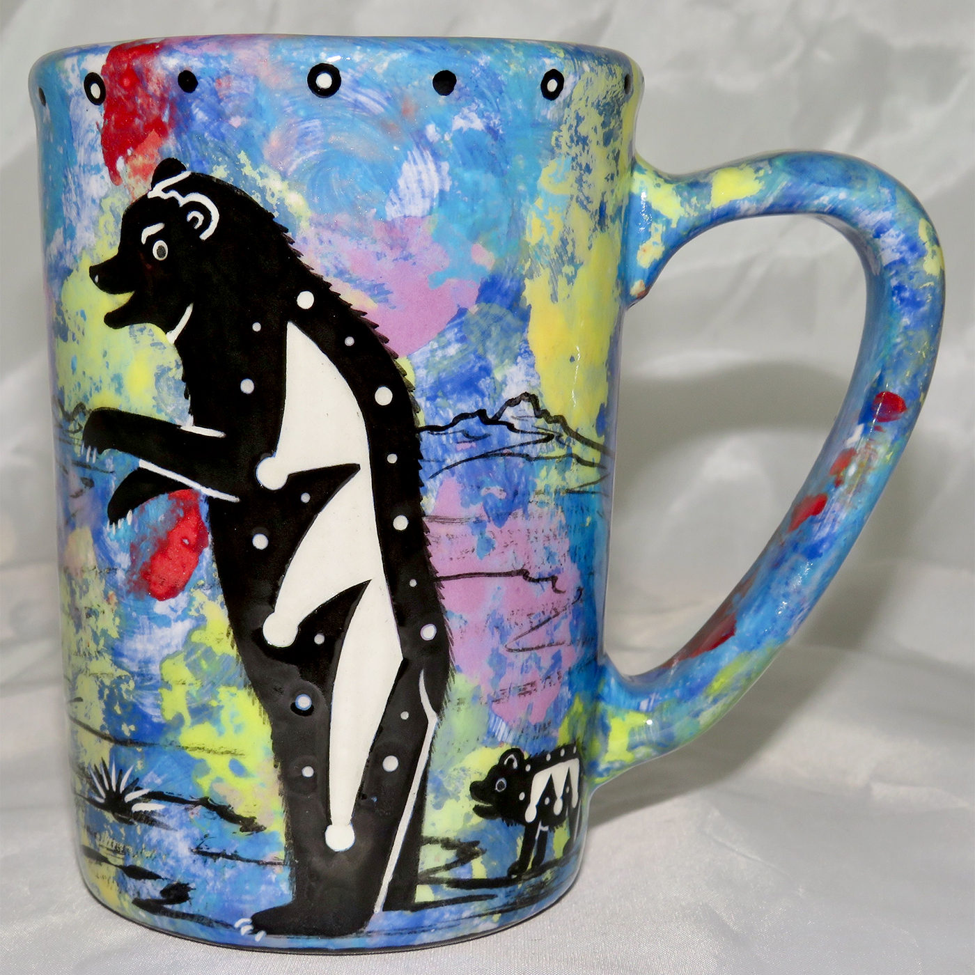 Mana Pottery Large Mug featuring bear and desert landscape on reverse sides, on blue background.