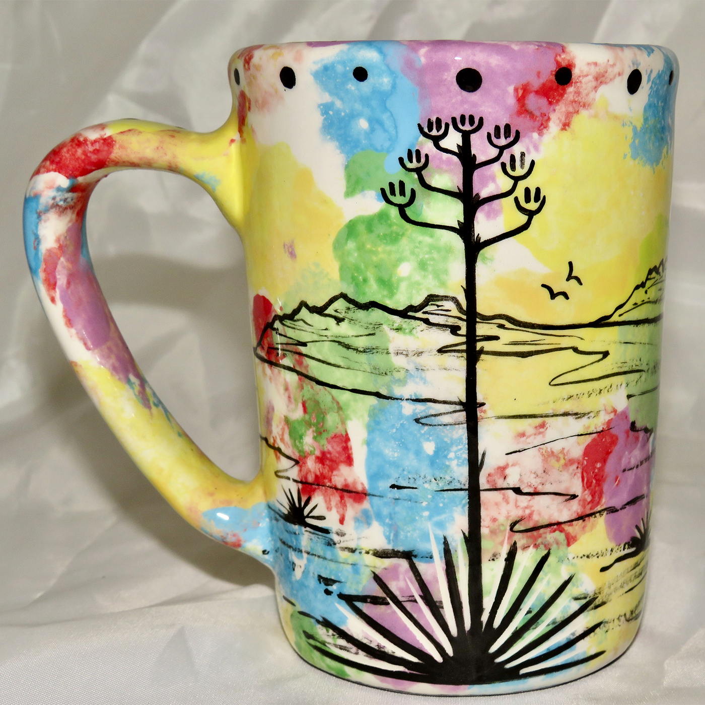 Mana Pottery Large Mug featuring deer and desert landscape on reverse sides, on mixed color background.