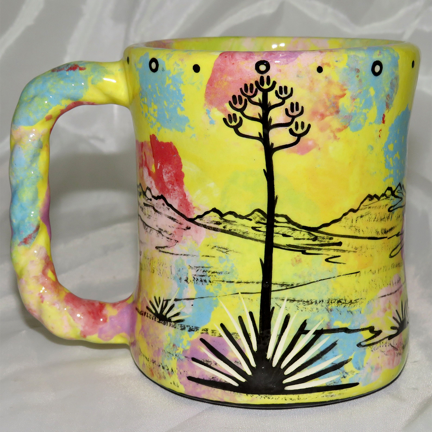 Mana Pottery Rope Mug featuring jumping deer on one side and desert vegetation on reverse.