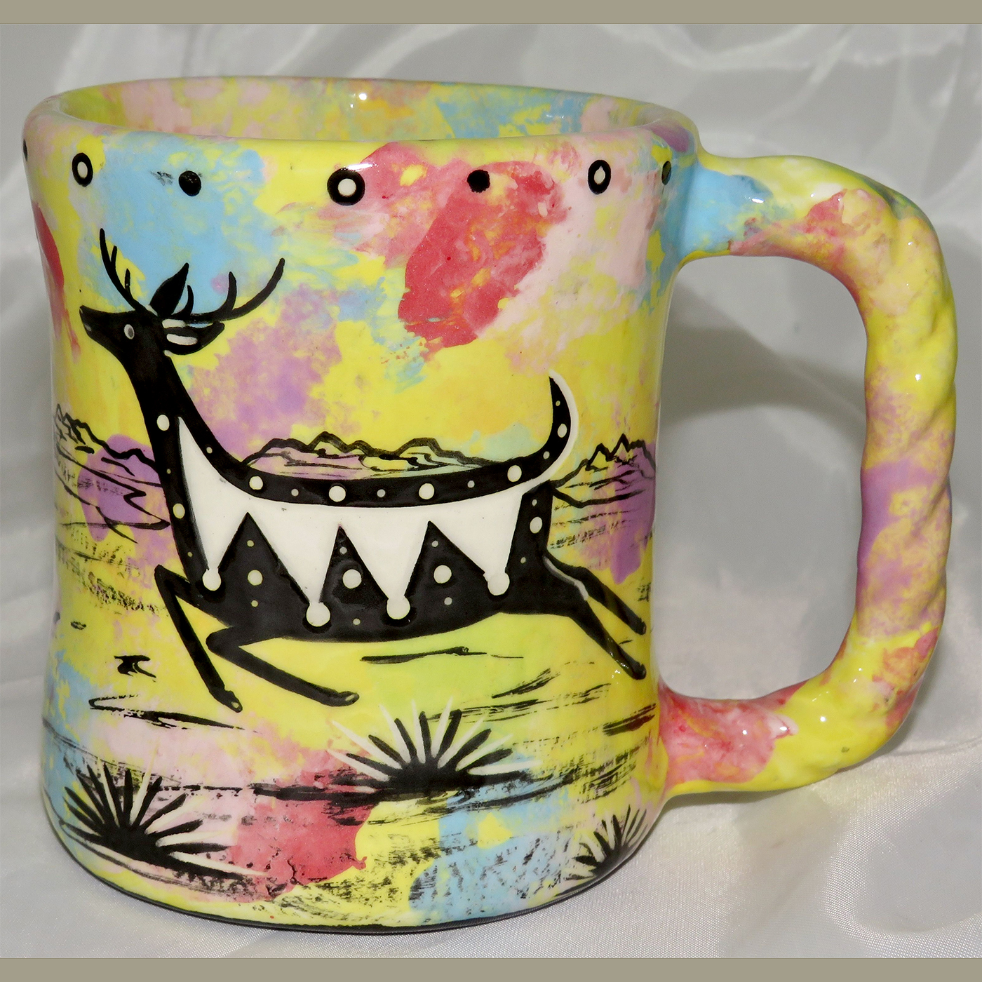 Mana Pottery Rope Mug featuring jumping deer on one side and desert vegetation on reverse.