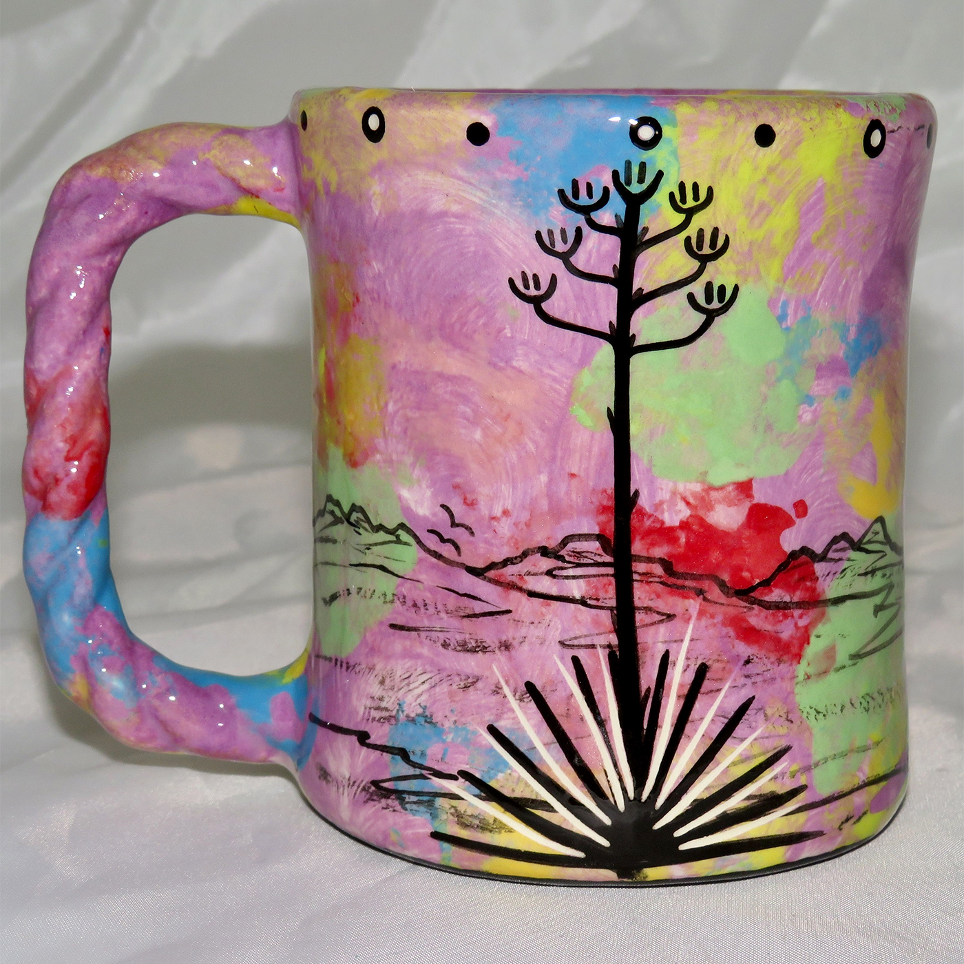 Mana Pottery Rope Mug featuring turtle on one side and desert vegetation on reverse, on green