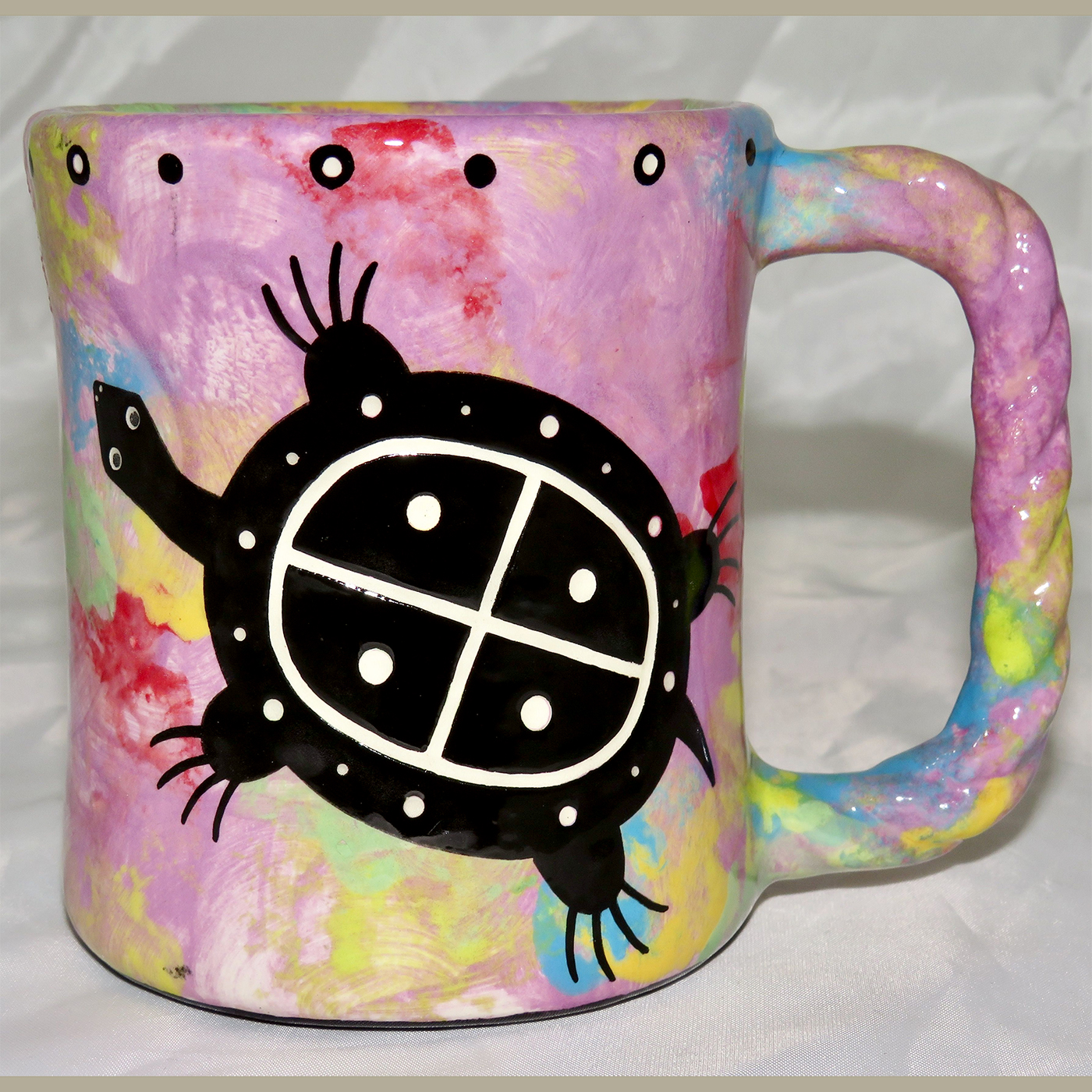 Mana Pottery Rope Mug featuring turtle on one side and desert vegetation on reverse, on green