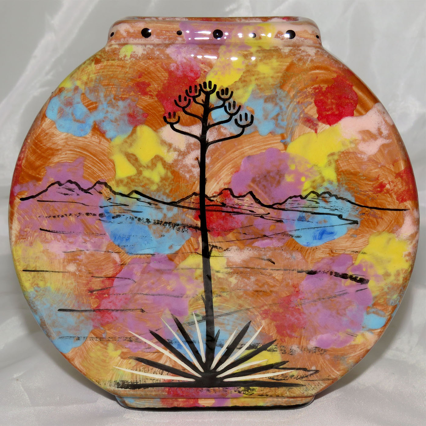 Pillow vase with leaping javelina mom and child. Reverse shows desert landscape.