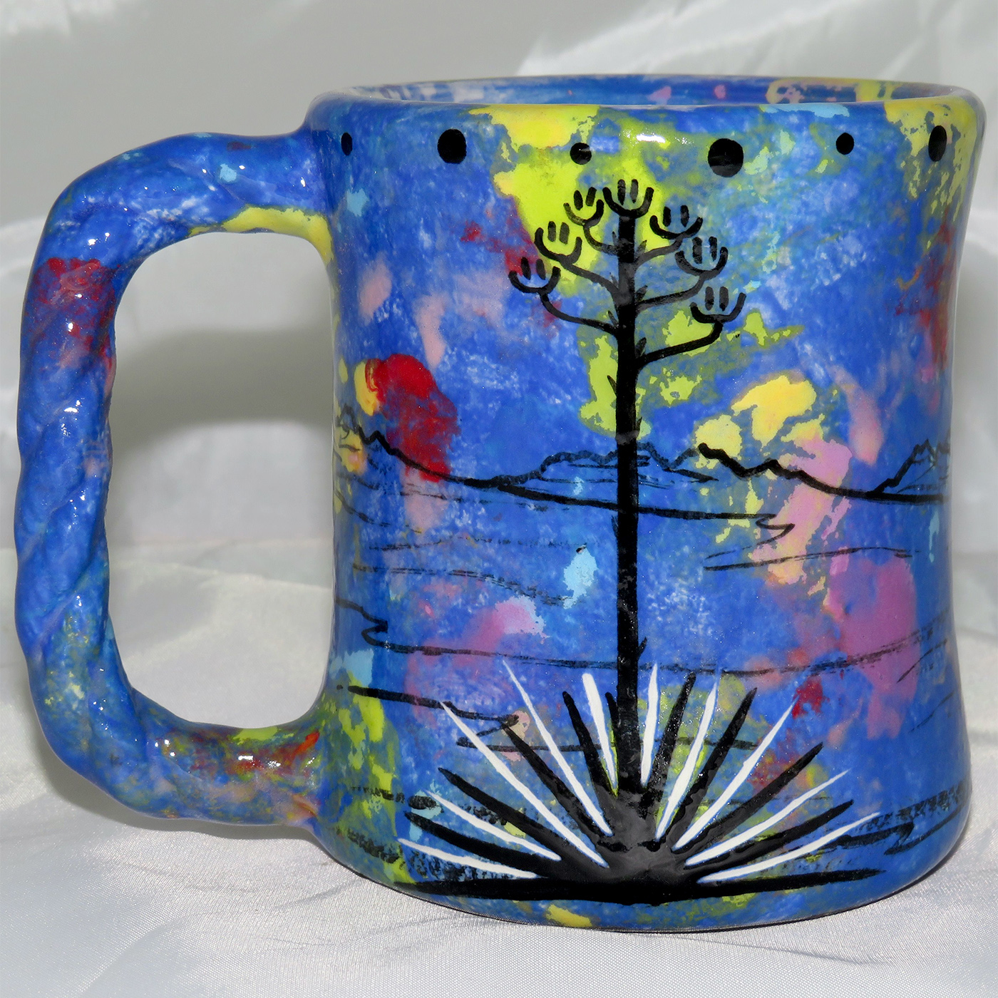 Mana Pottery rope mug featuring coyote with desert landscape on reverse.