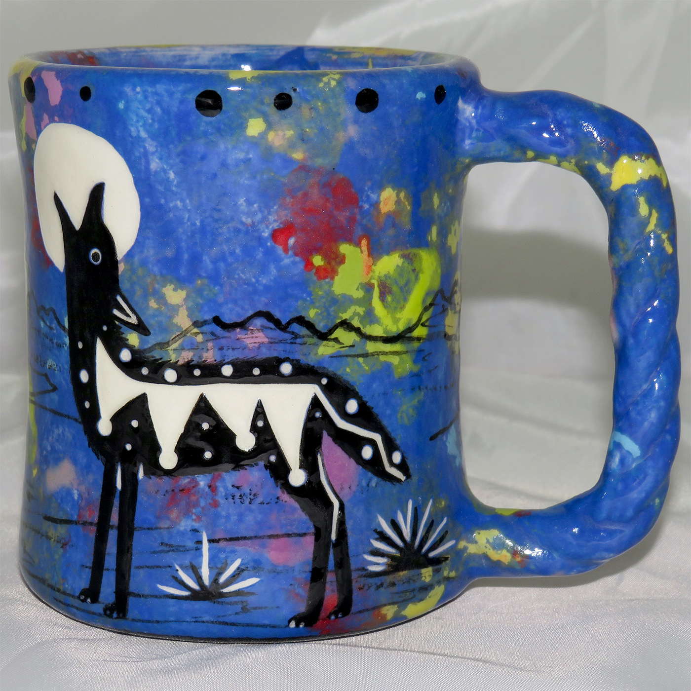 Mana Pottery rope mug featuring coyote with desert landscape on reverse.