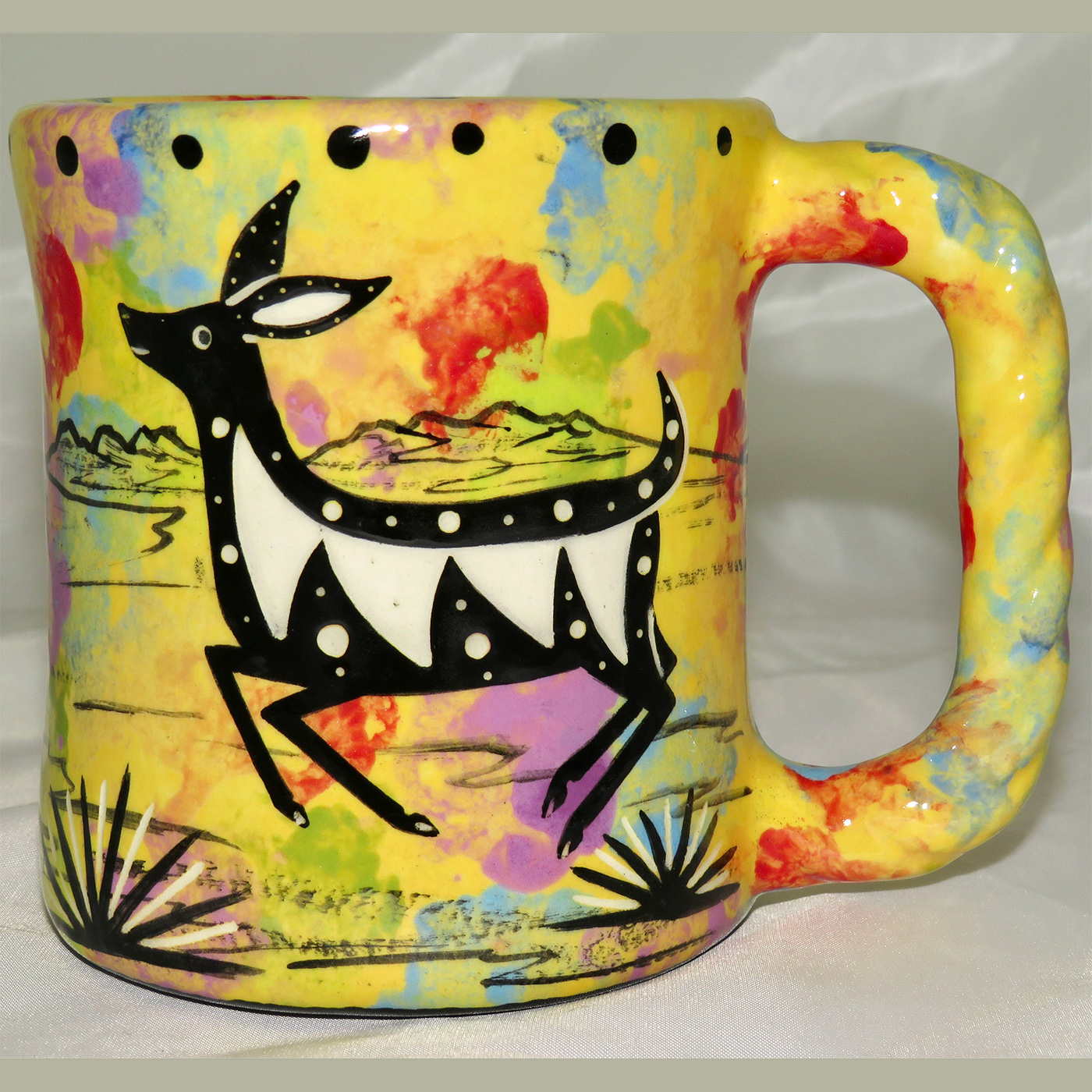Mana Pottery rope mug featuring deer and desert landscape on reverse.