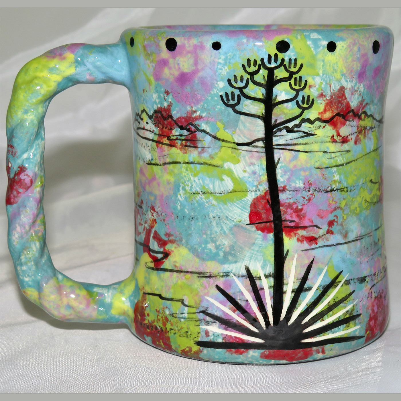 Mana Pottery rope mug featuring roadrunner and desert landscape on reverse.