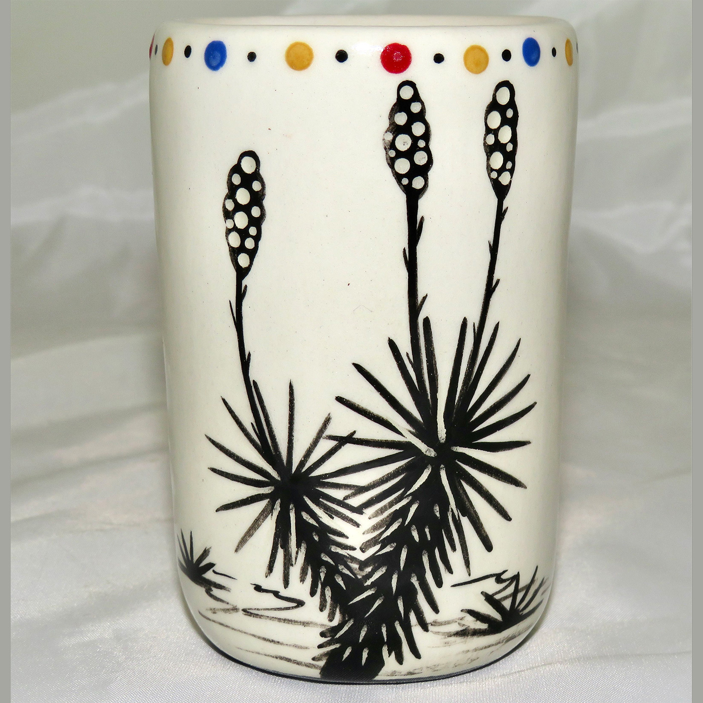 Mana Pottery clay pottery shot glass featuring Peyote button on one side and desert plants on reverse.