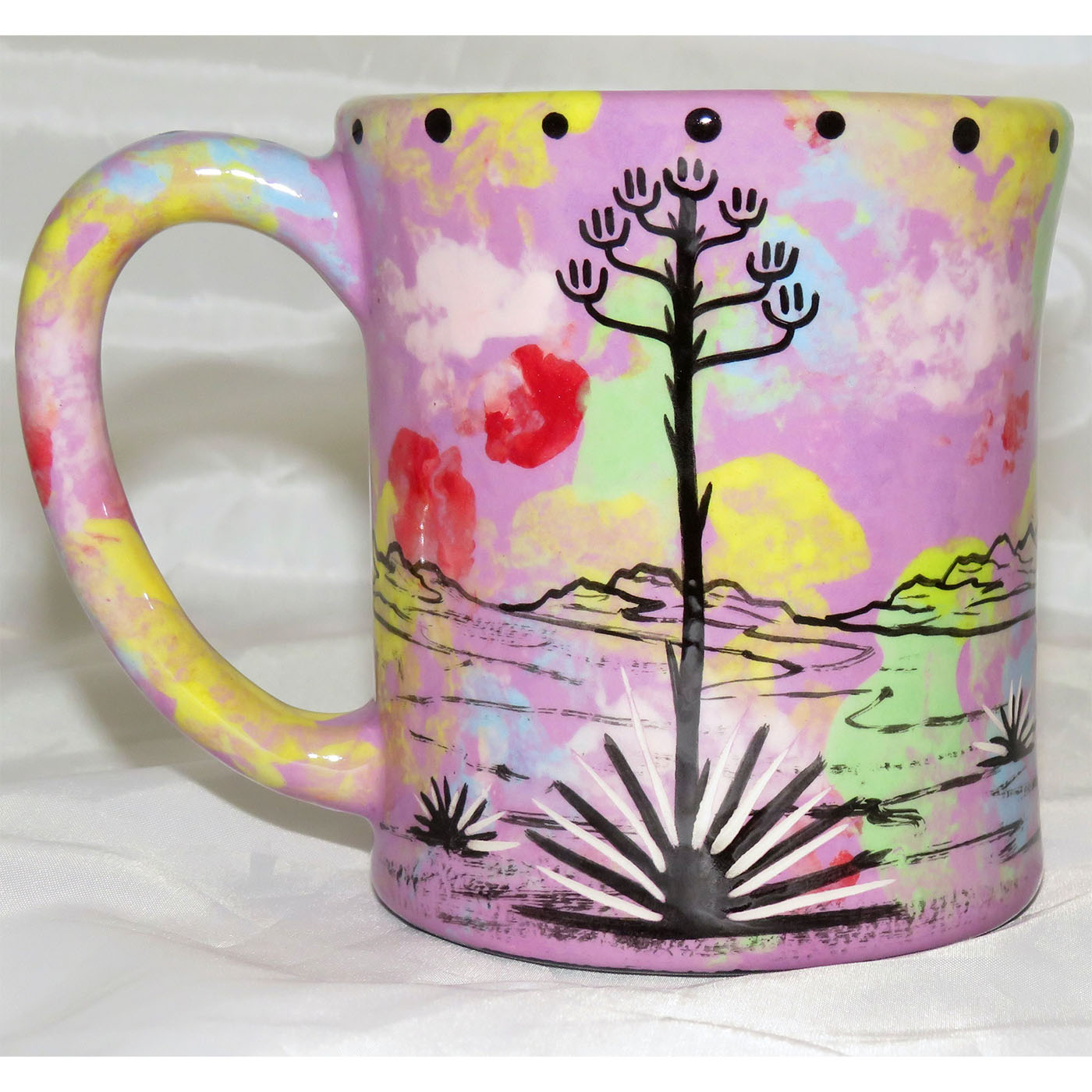 Mana Pottery emug with coyote and desert landscape on lavender background.