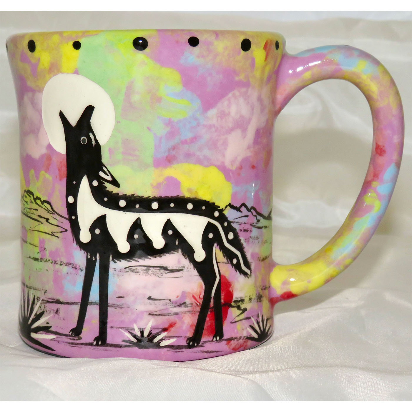 Mana Pottery emug with coyote and desert landscape on lavender background.