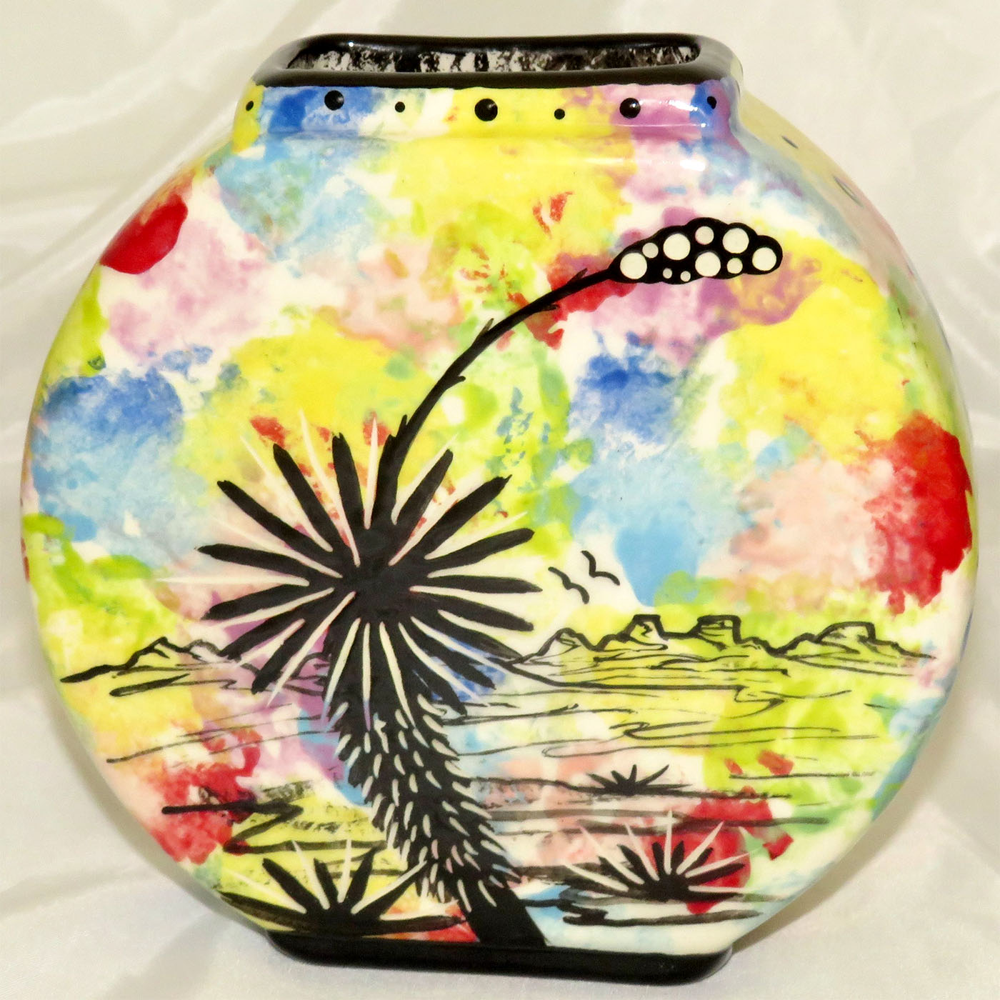 Mana Pottery pillow vase featuring horse and desert landscape on reverse sides, on confetti background..