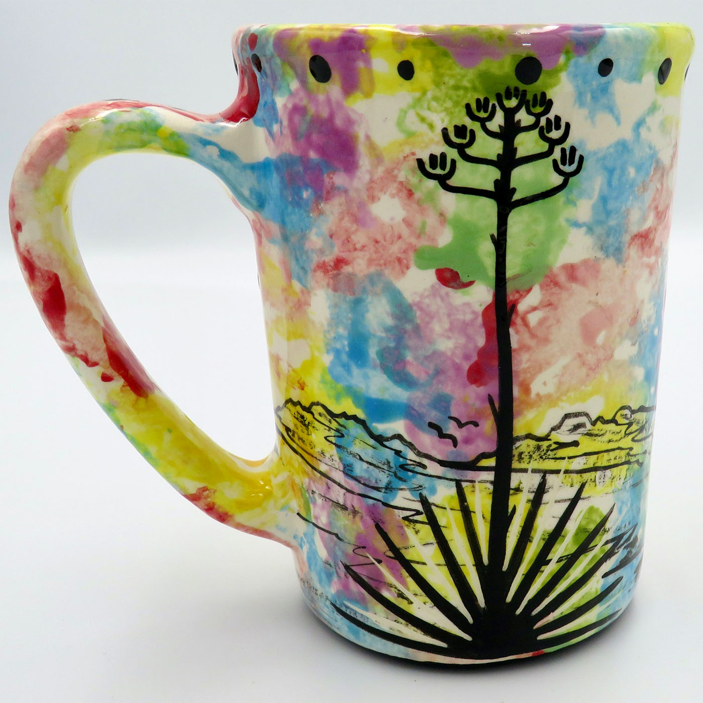 Mana Pottery large mug featuring mama bear with baby and desert landscape on reverse, on confetti background.