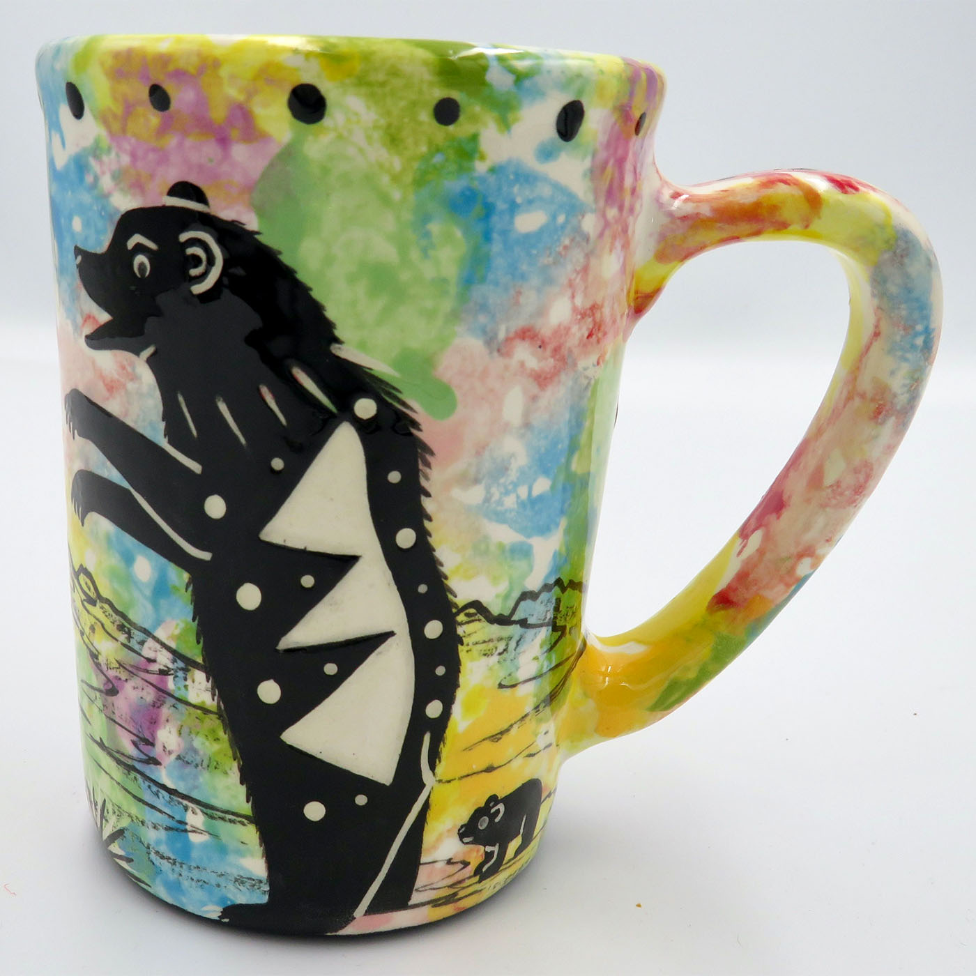 Mana Pottery large mug featuring mama bear with baby and desert landscape on reverse, on confetti background.