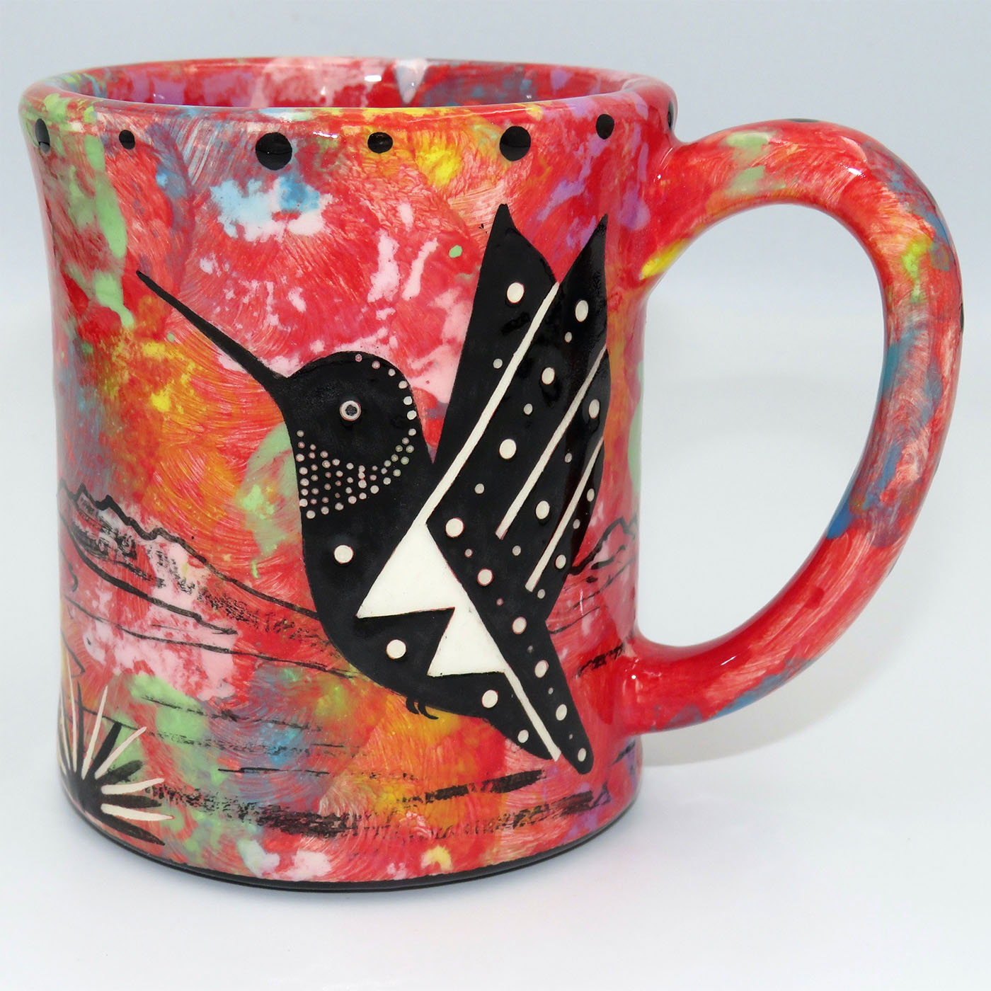 Mana Pottery e-mug featuring hummingbird and desert landscape on crimson background.