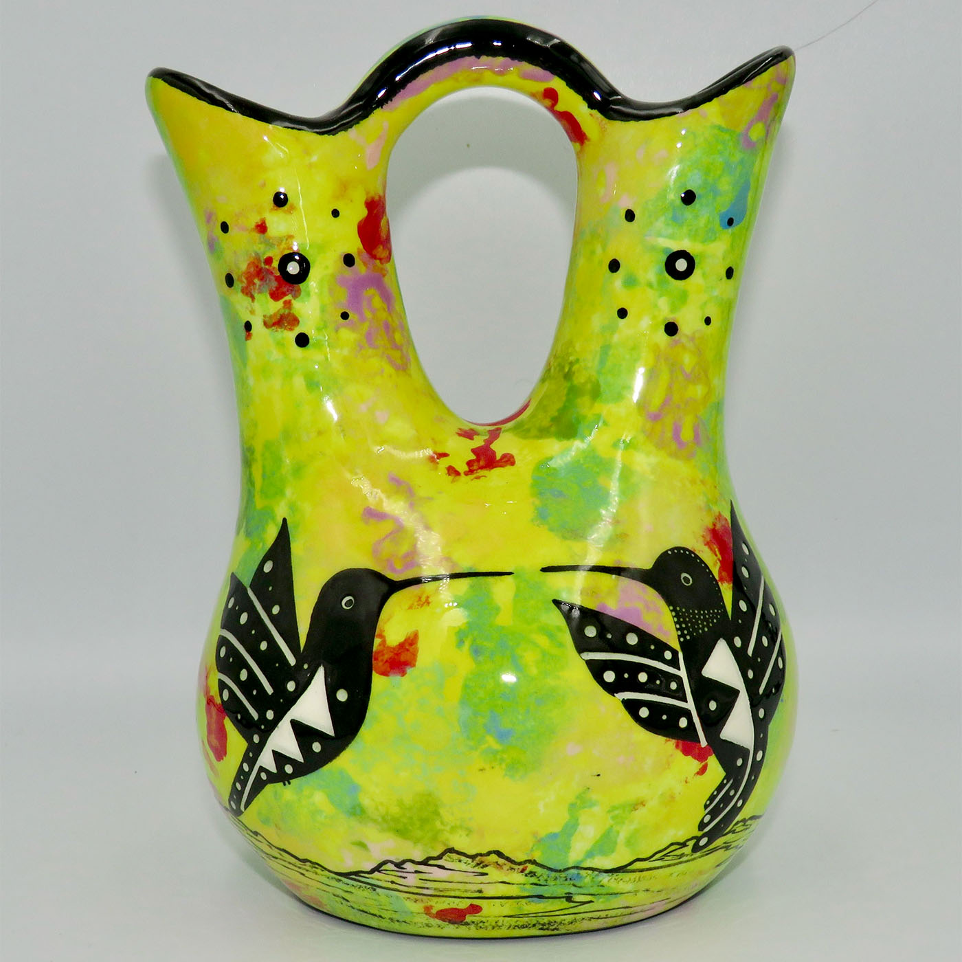 Mana Pottery medium wedding vase featuring kissing hummingbirds and desert landscape on bright yellow background