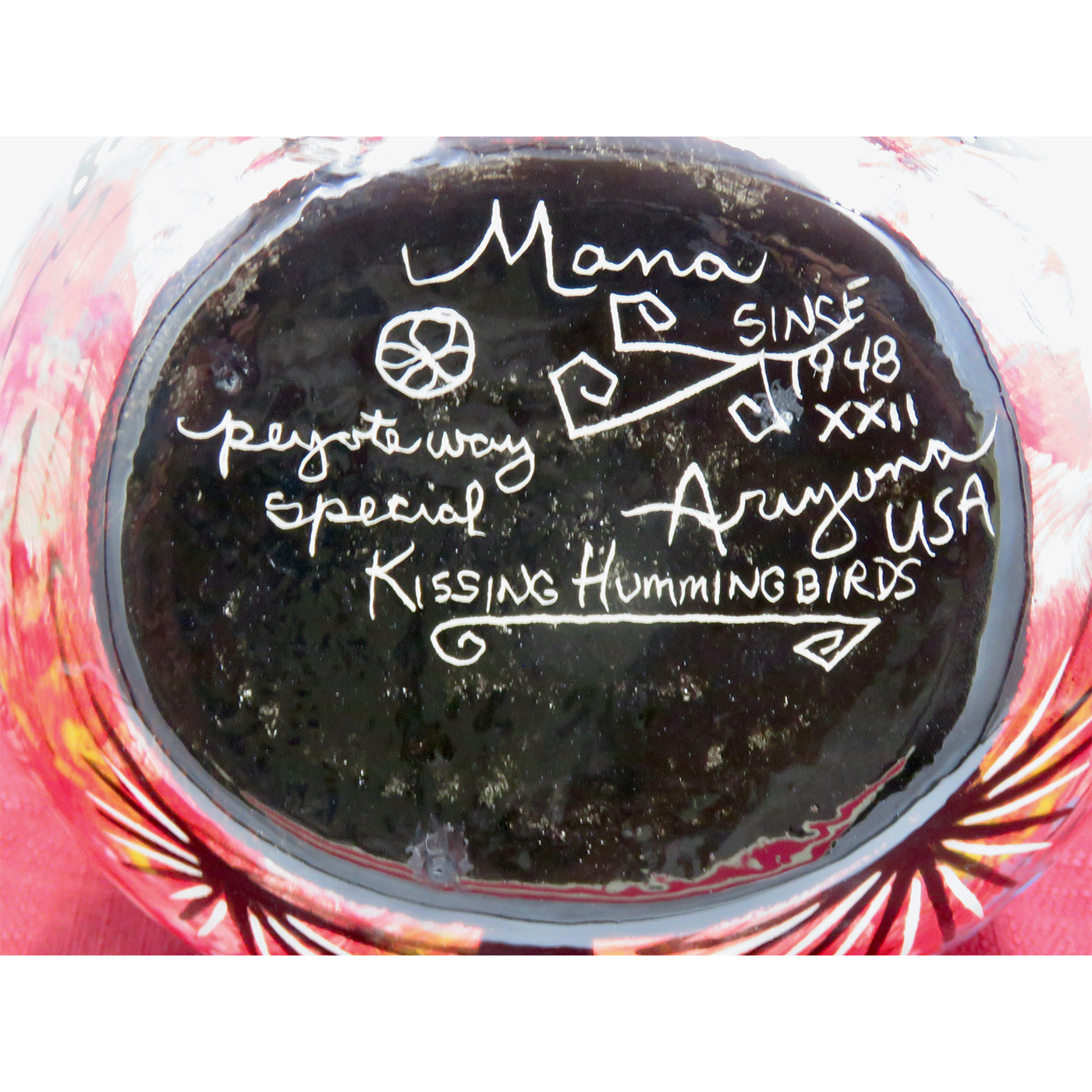Mana Pottery medium wedding vase featuring kissing hummingbirds and desert landscape on crimson backgroundMana Pottery medium wedding vase featuring kissing hummingbirds and desert landscape on reverse sides on blue background. This pic shows the bottom with artist signature.