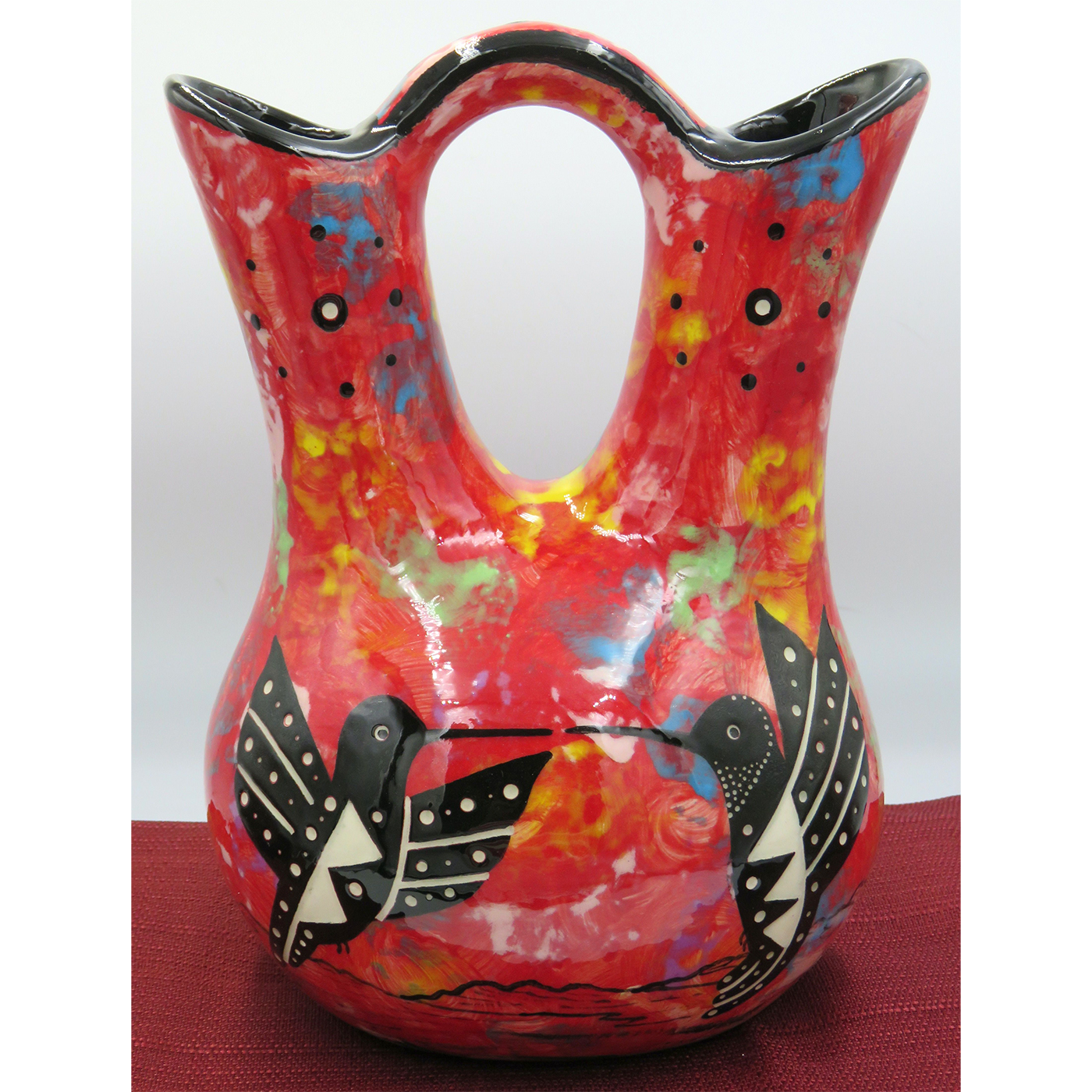 Mana Pottery medium wedding vase featuring kissing hummingbirds and desert landscape on crimson background