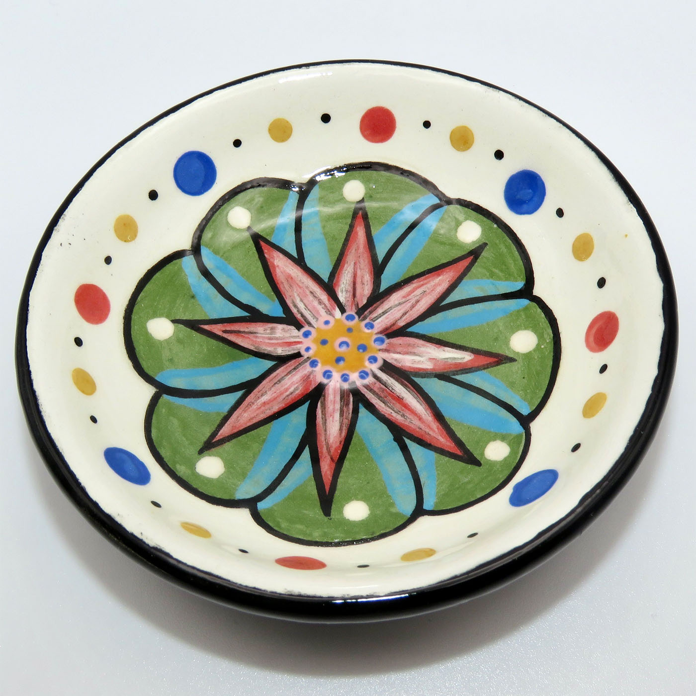 Mana Pottery teabag holder featuring Peyote in bloom, with marbled black and white underside.