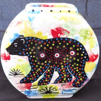Image of Mana Pottery Pillow Vase featuring bear and desert vegetation on reverse sides, on confetti background.
