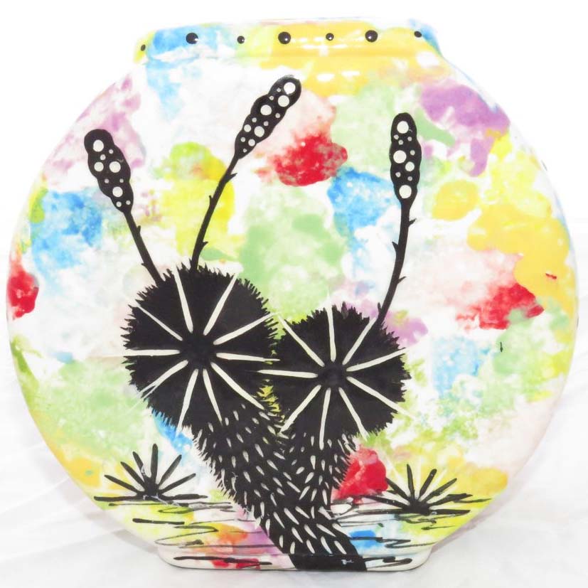 Image of Mana Pottery Pillow Vase featuring bear and desert vegetation on reverse sides, on confetti background.