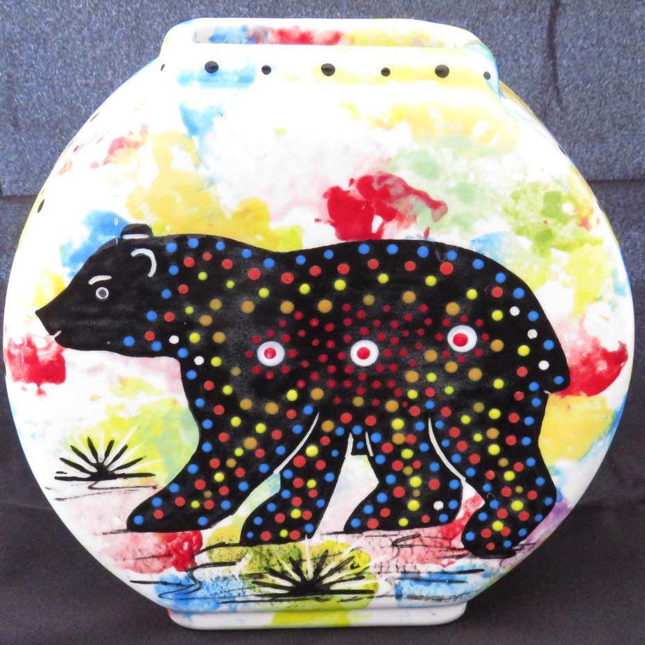 Image of Mana Pottery Pillow Vase featuring bear and desert vegetation on reverse sides, on confetti background.