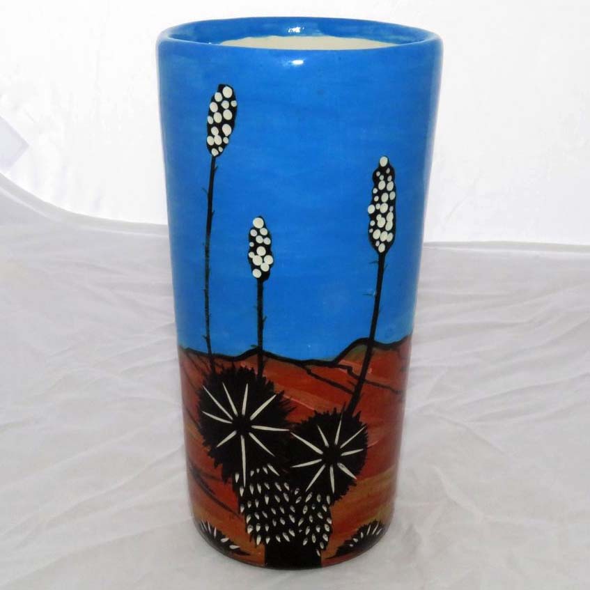 Image of Mana Pottery tumbler featuring Spirit Walker in brilliant blue sky and desert landscape.