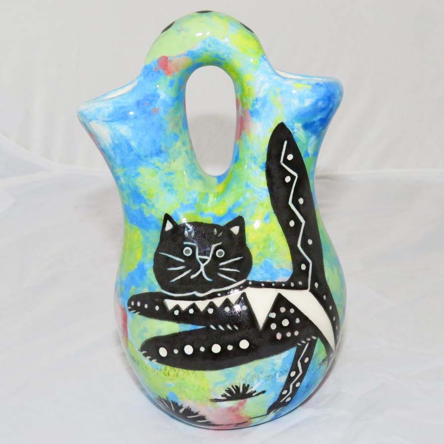 Image of Mana Pottery Tiny Wedding Vase featuring kitty with desert plants on reverse, on turquoise blue background.