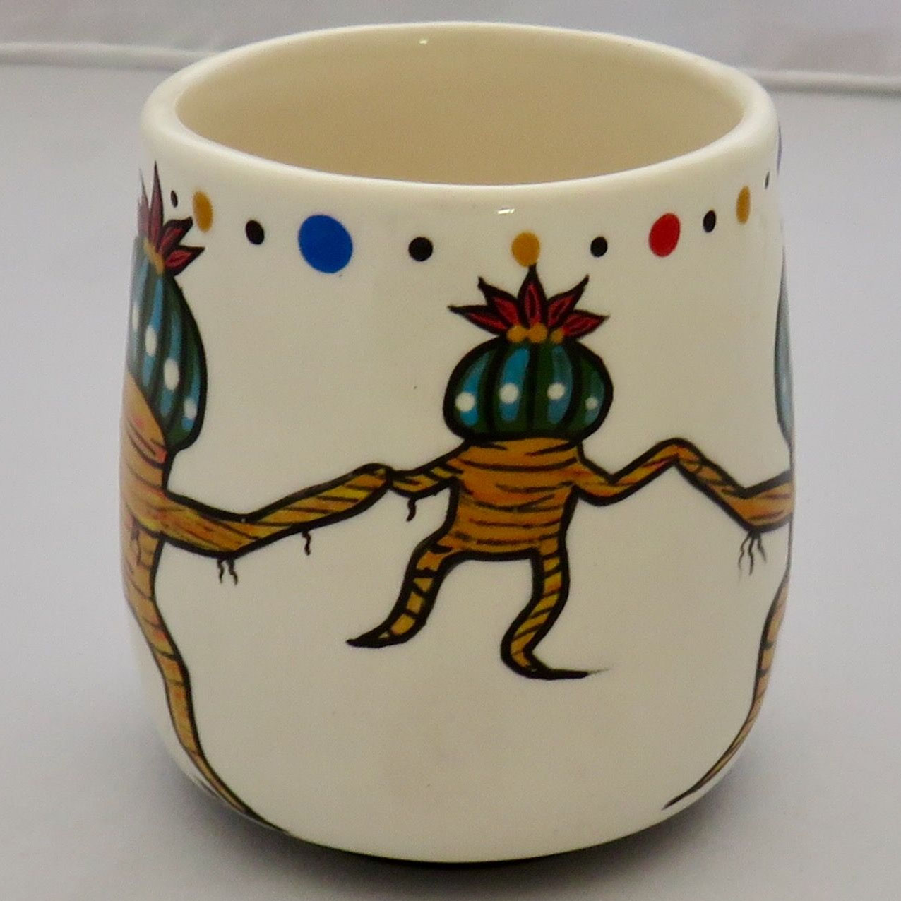 Image of Mana Pottery Country Cup featuring Dancing Peyote Family. No handle.