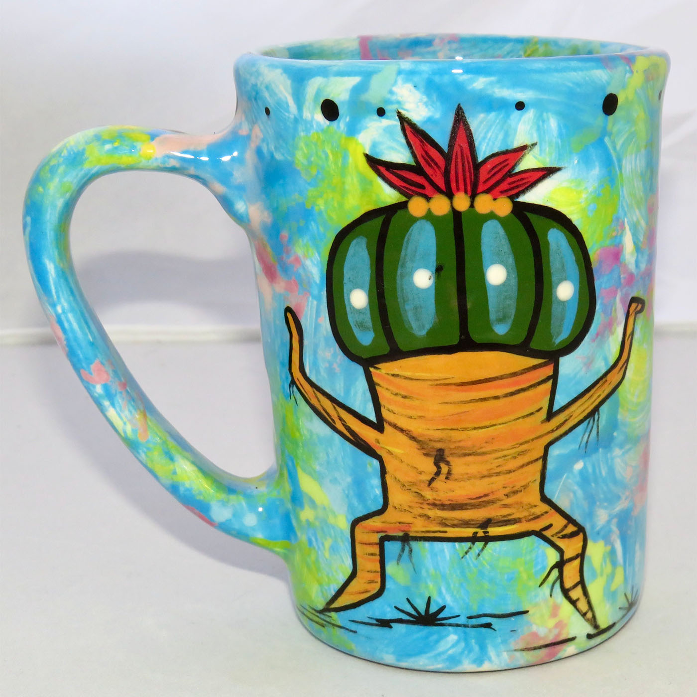 Image of Mana Pottery Large Mug featuring black Chakra Being on one side and Dancing Peyote on the other on turquoise blue background.