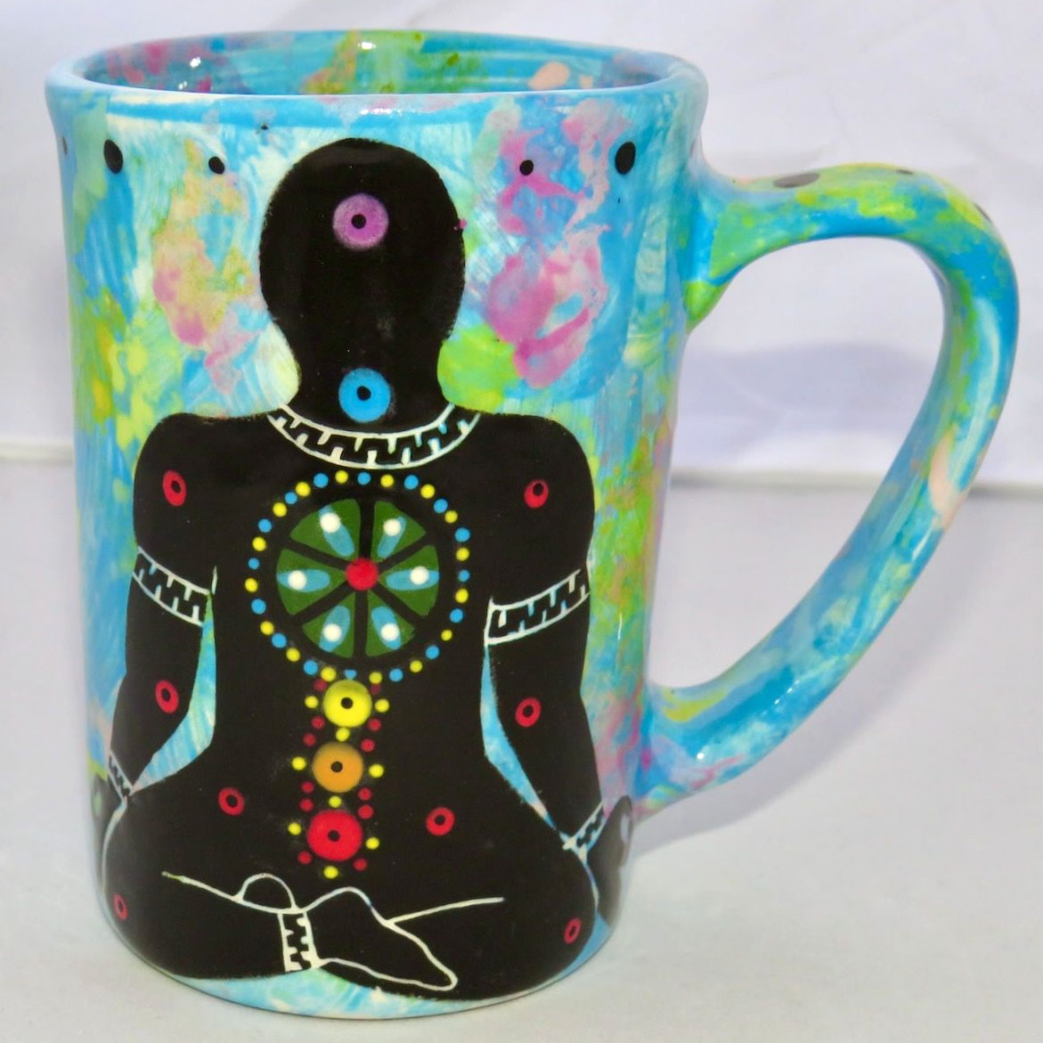 Image of Mana Pottery Large Mug featuring black Chakra Being on one side and Dancing Peyote on the other on turquoise blue background.
