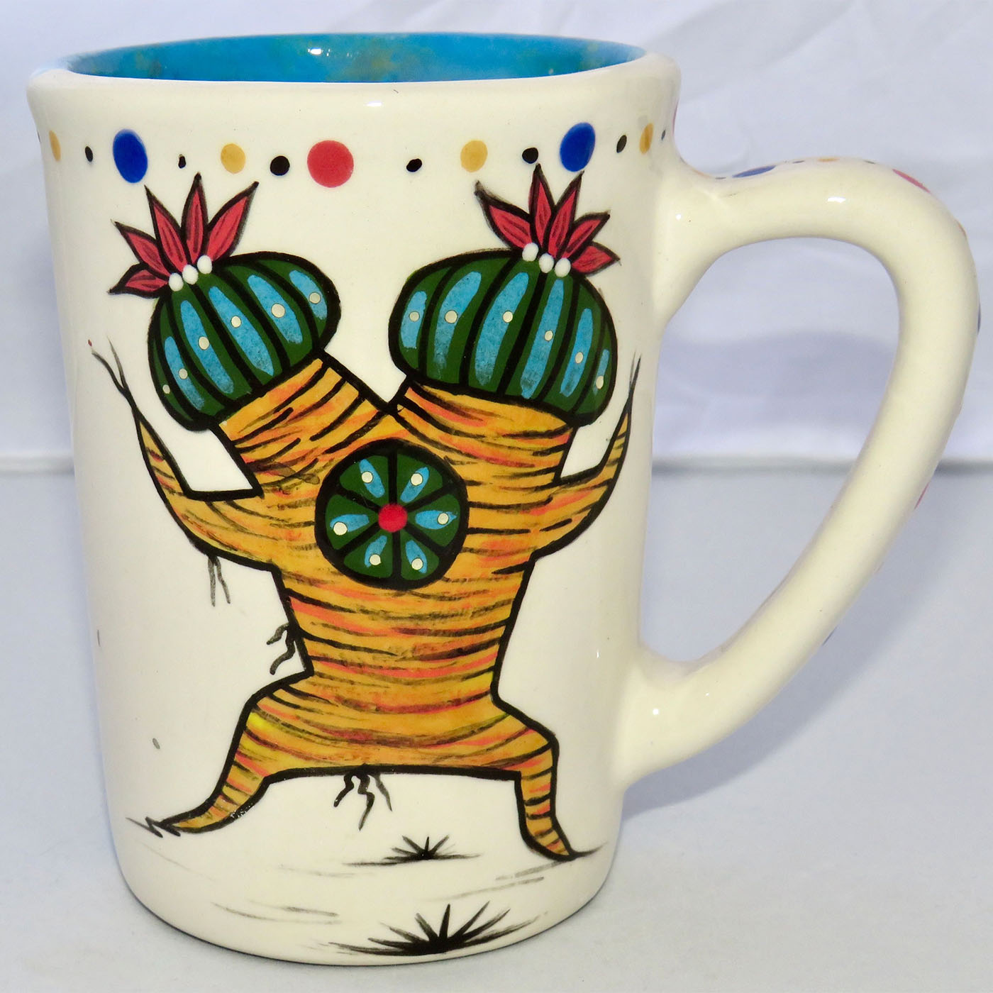 Image of Mana Pottery Large Mug featuring Dancing Peyote Couple on one side and desert vegetation on turquoise blue on reverse.