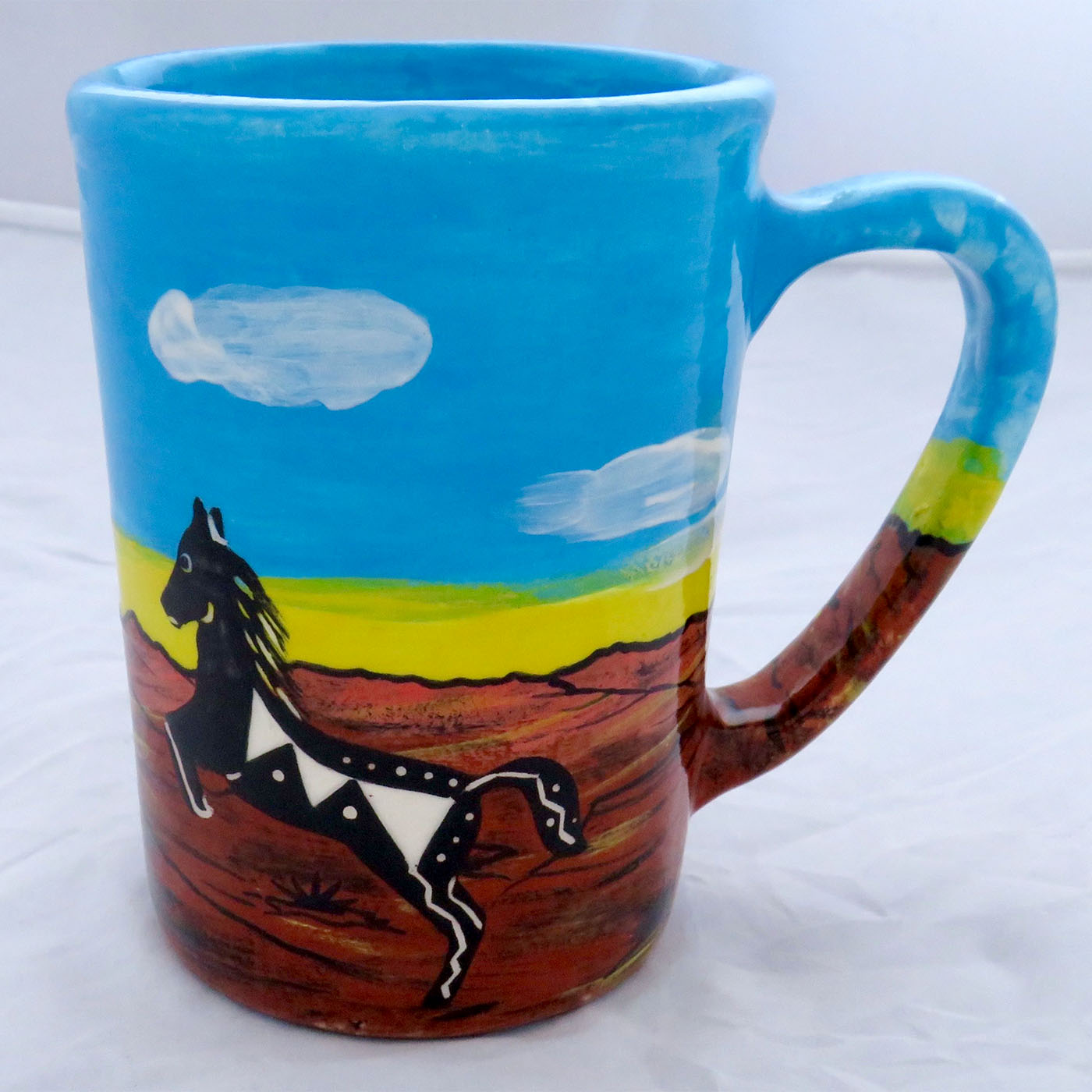 Image of Mana Pottery large mug featuring horse and hawk against desert earth and sky.