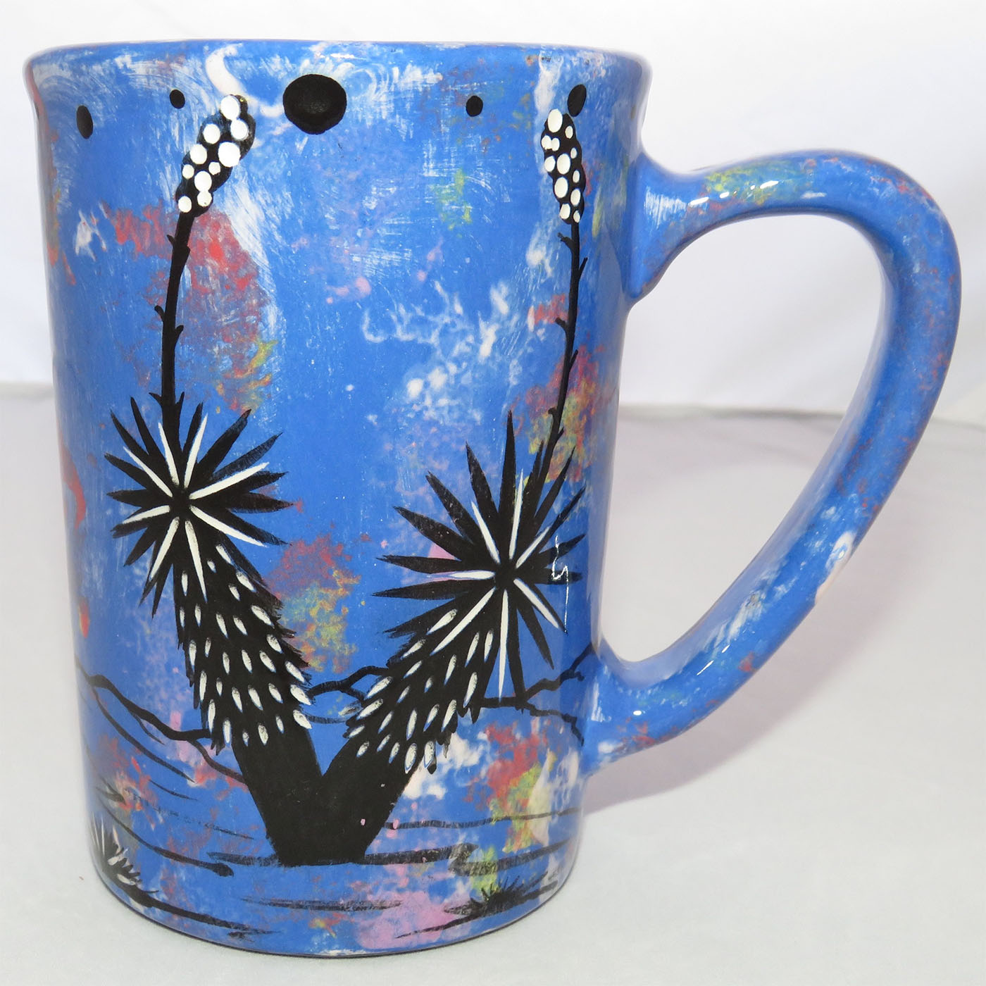 Image of Mana Pottery Large Mug featuring Mountain Sheep on one side and desert vegetation on the other on a background of blue. (desert cactus view)