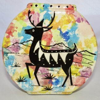 Image of Mana Pottery Pillow Vase featuring deer and desert vegetation on reverse sides, on confetti background.