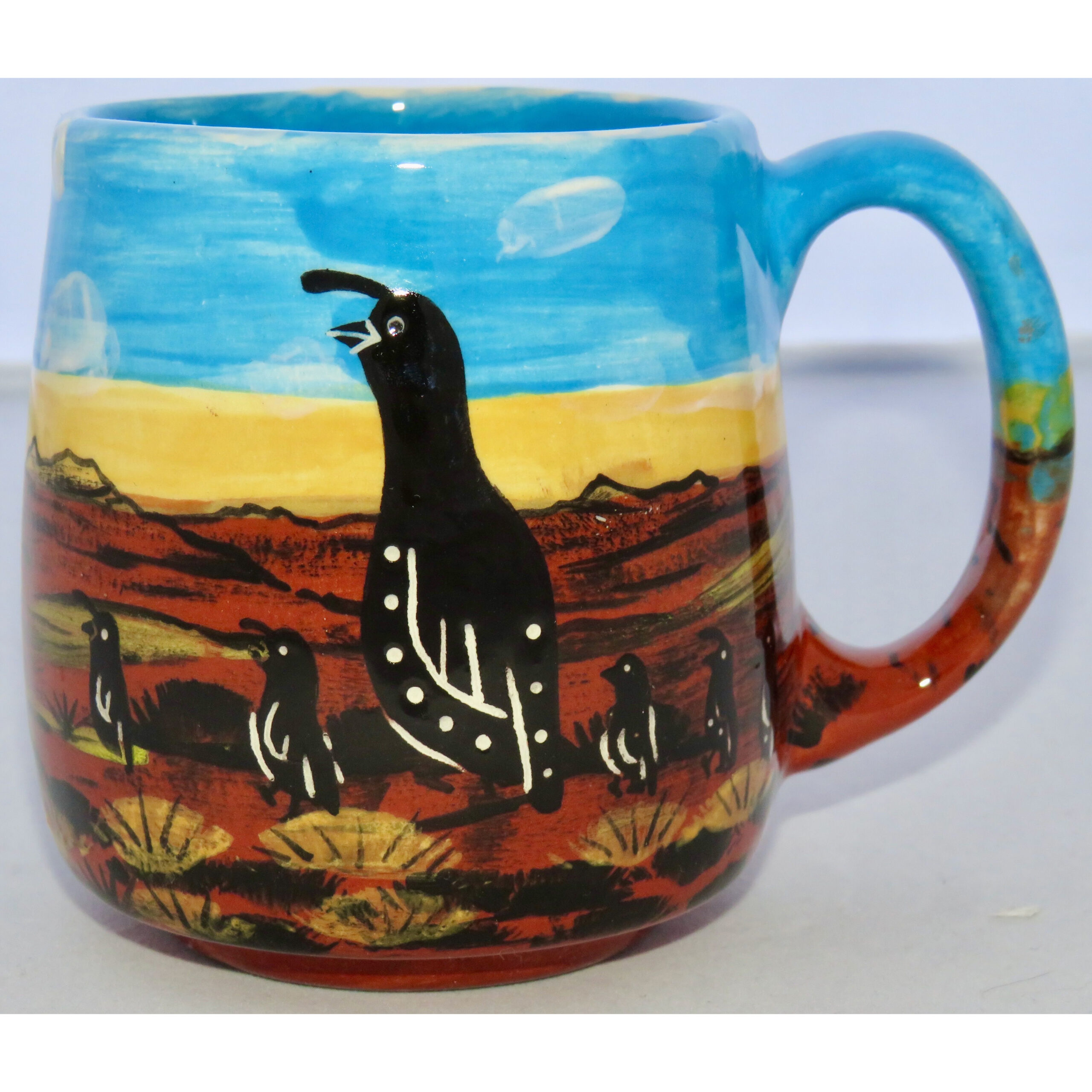 Mana Pottery Country Cup featuring quail family one side and doggy on the other, on background of desert earth and sky