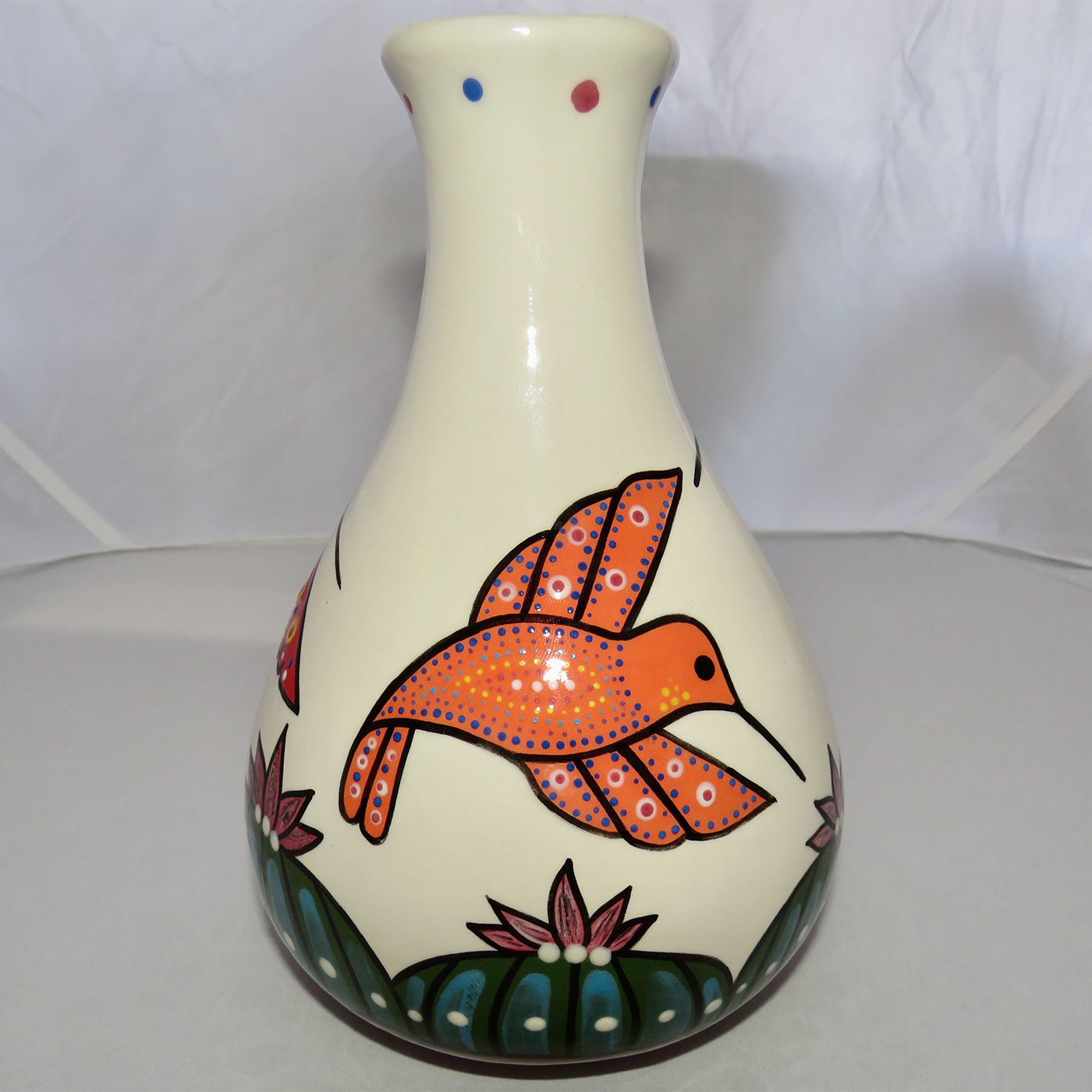 Mana Pottery Teardrop Vase featuring a blue, red and orange hummingbird hovering above Peyote.